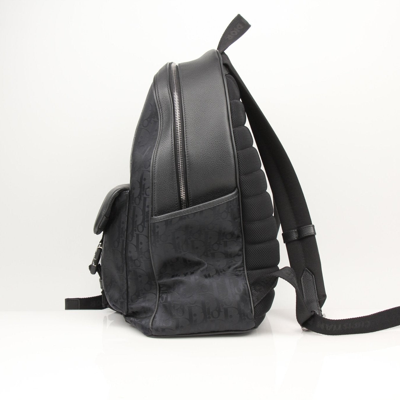 Christian Dior Oblique nylon backpack with adjustable straps and gold-tone hardware, ideal for travel and everyday use