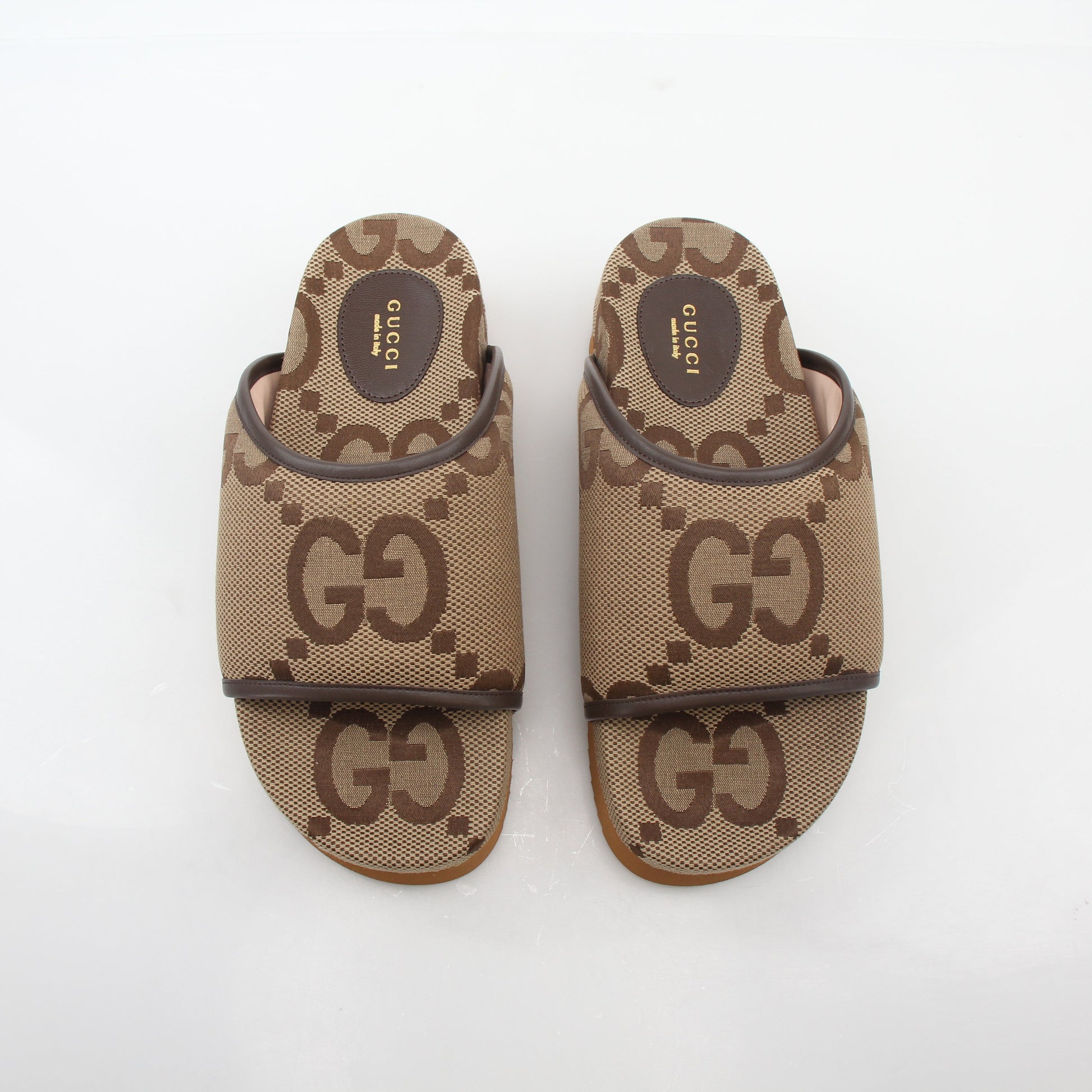 Gold & Beyond Gucci brown maxi GG platform slide sandals, stylish shoes with bold logo design and comfortable slip-on style.