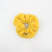 Prada yellow terry cloth logo scrunchie, a stylish accessory with Prada branding and soft textured fabric.