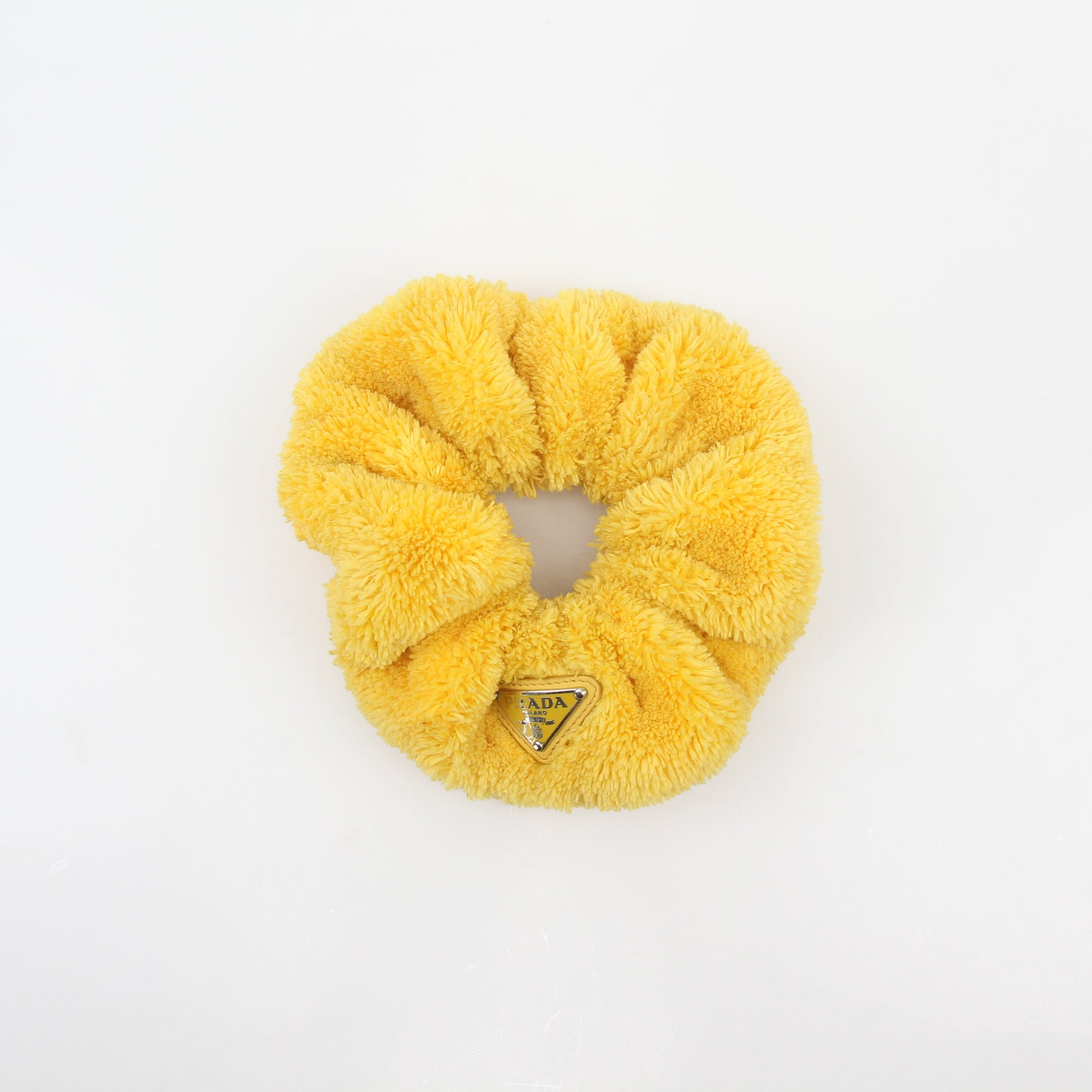 Prada yellow terry cloth logo scrunchie, a stylish accessory with Prada branding and soft textured fabric.