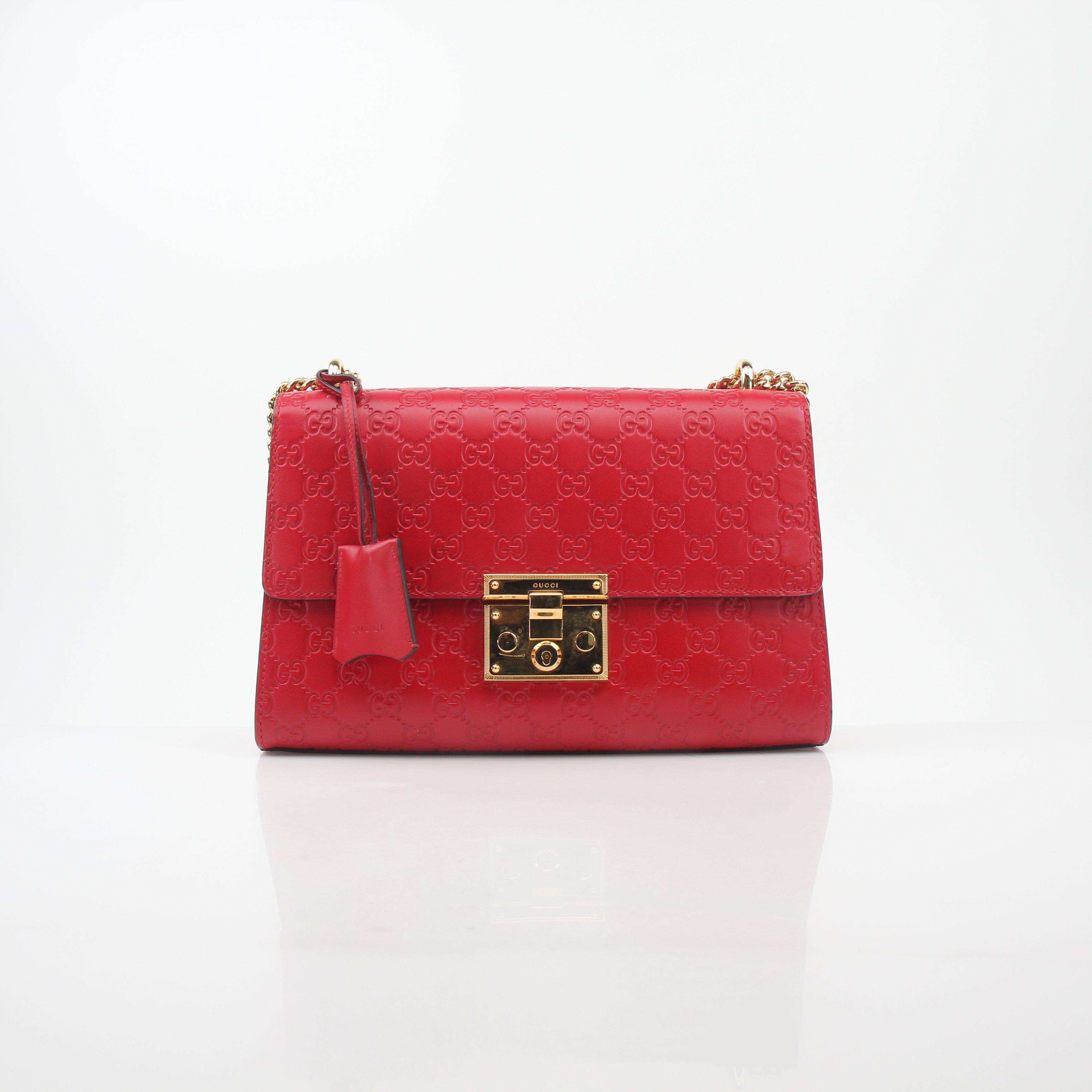 Gucci red GG signature padlock medium shoulder handbag with gold hardware and adjustable strap, stylish and iconic designer bag.
