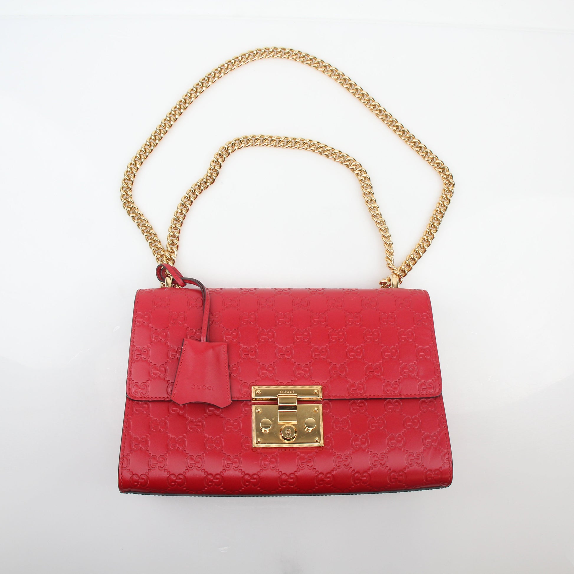Gucci Red GG Signature Padlock Medium Shoulder Bag with gold hardware and adjustable strap, featuring signature design and structured shape.