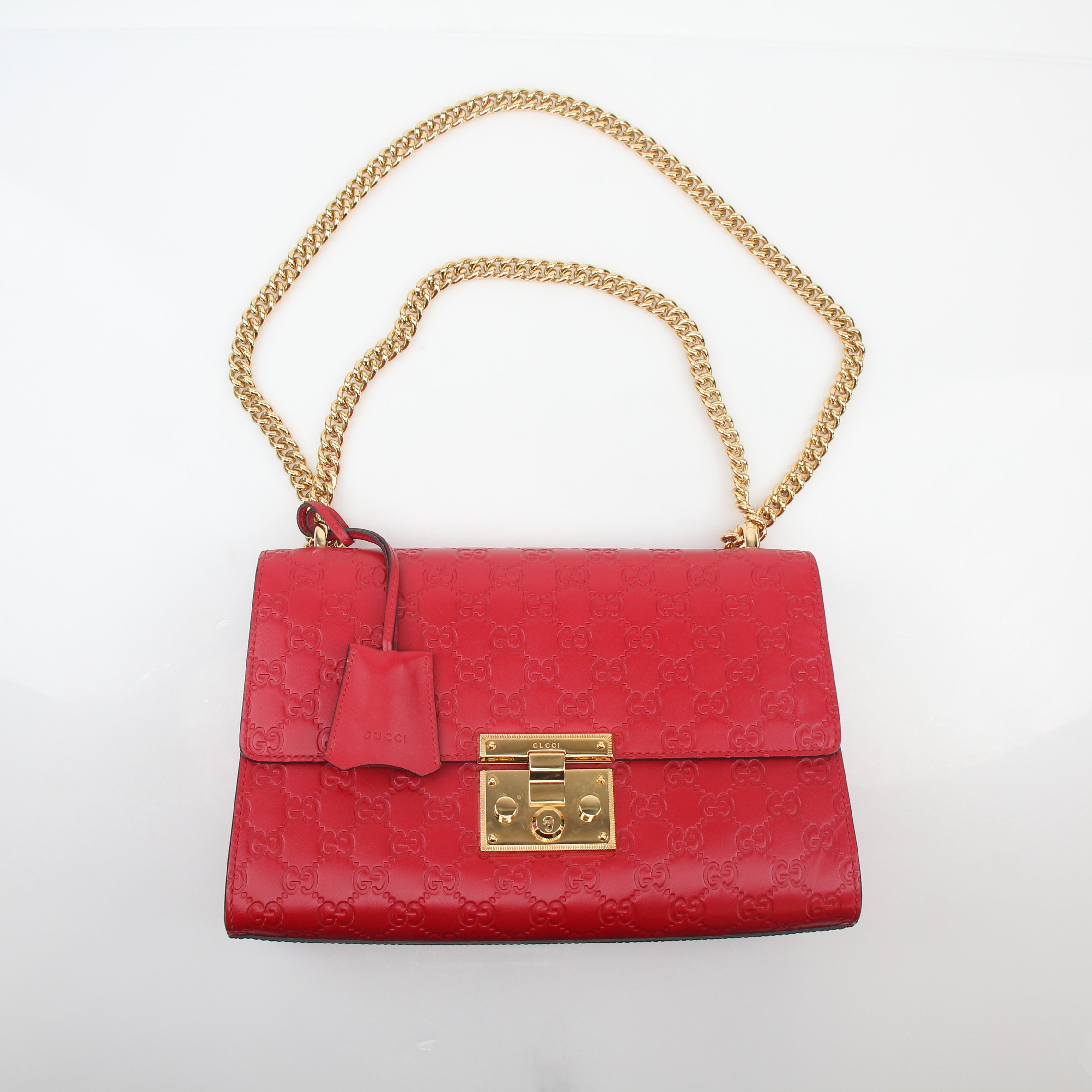Gucci Red GG Signature Padlock Medium Shoulder Bag with gold hardware and adjustable strap, featuring signature design and structured shape.