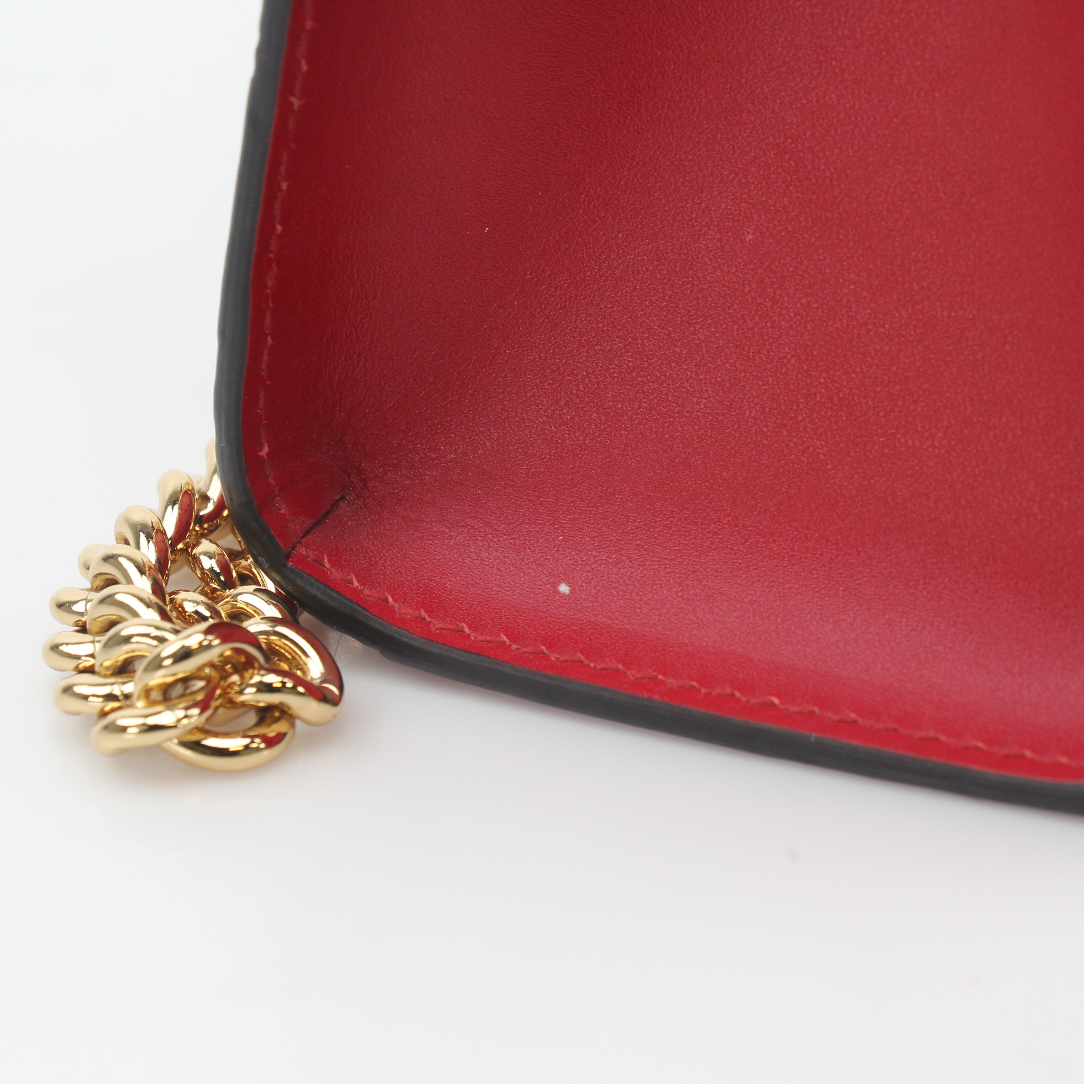 Gucci red GG signature medium shoulder bag with padlock, featuring gold hardware and a sleek leather strap.