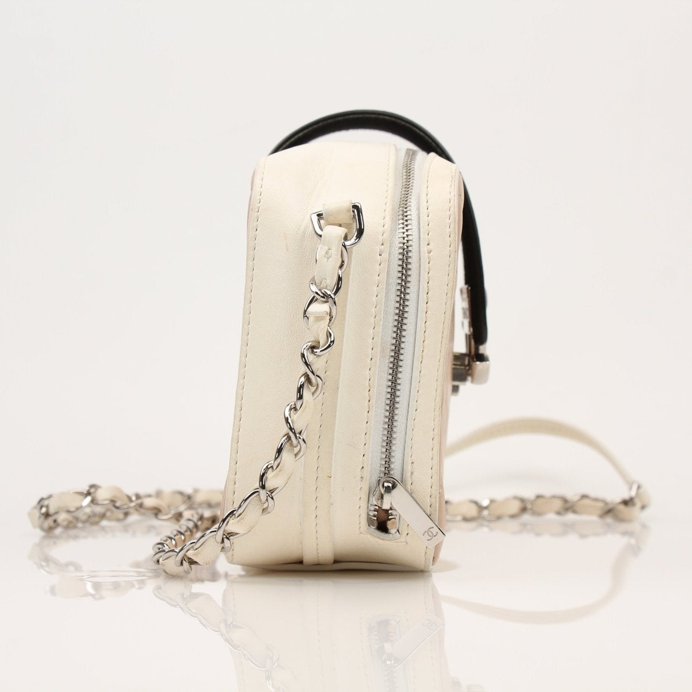 Gold & Beyond Chanel two-tone quilted mini flap handbag with gold and black accents, stylish and compact accessory.