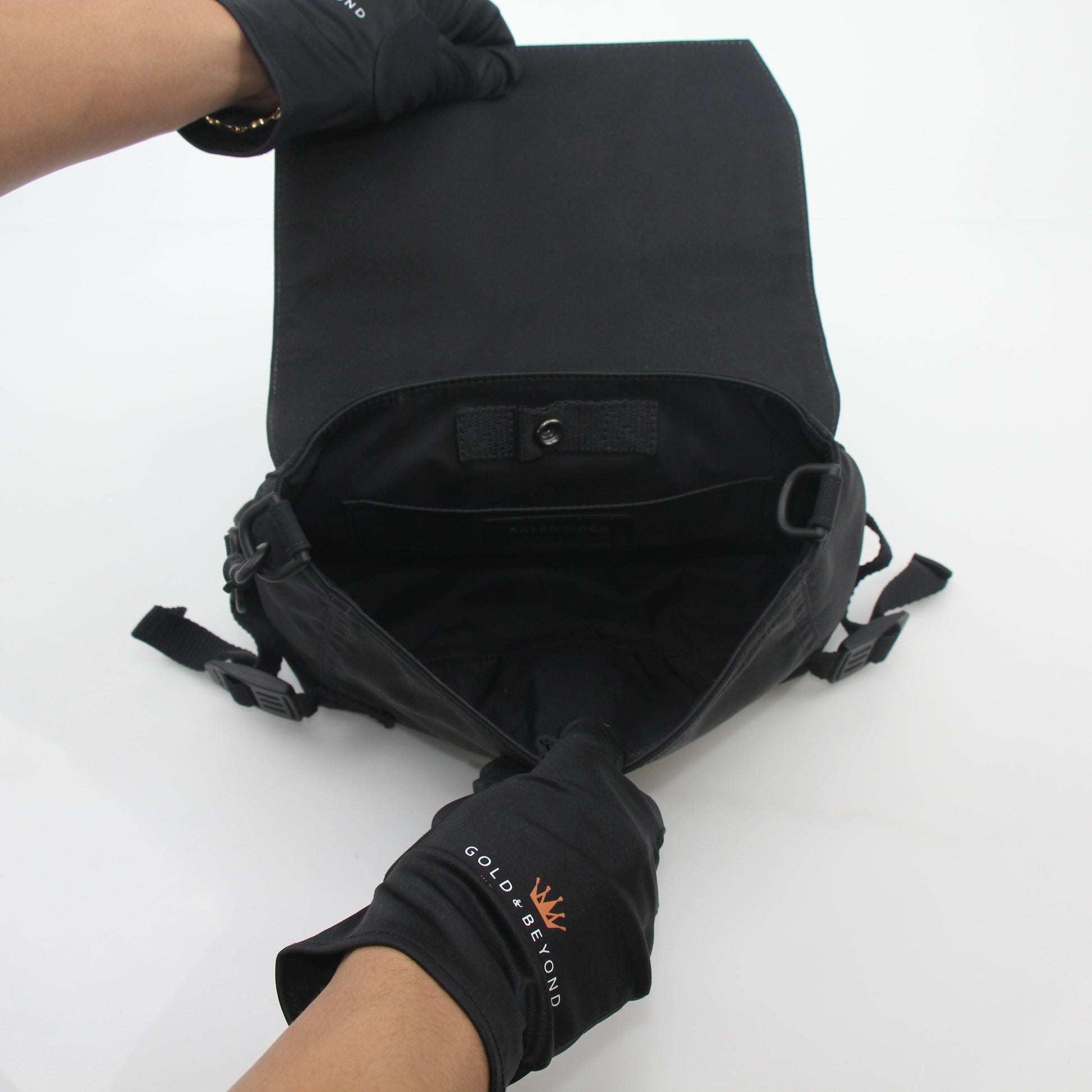Black Balenciaga Army Messenger Bag by Gold & Beyond, featuring a structured handbag with adjustable strap and front flap closure.