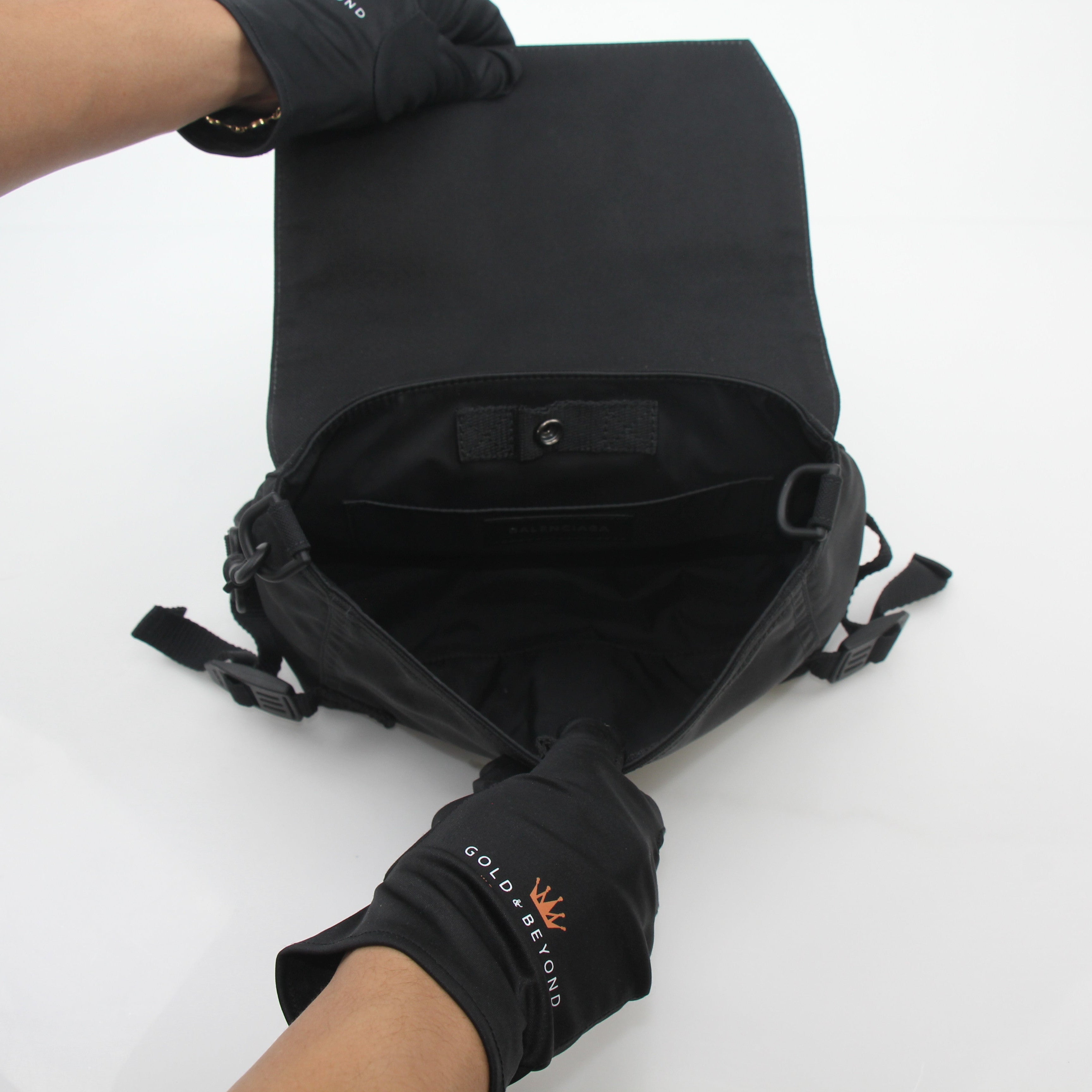 Black Balenciaga Army Messenger Bag by Gold & Beyond, featuring a structured handbag with adjustable strap and front flap closure.