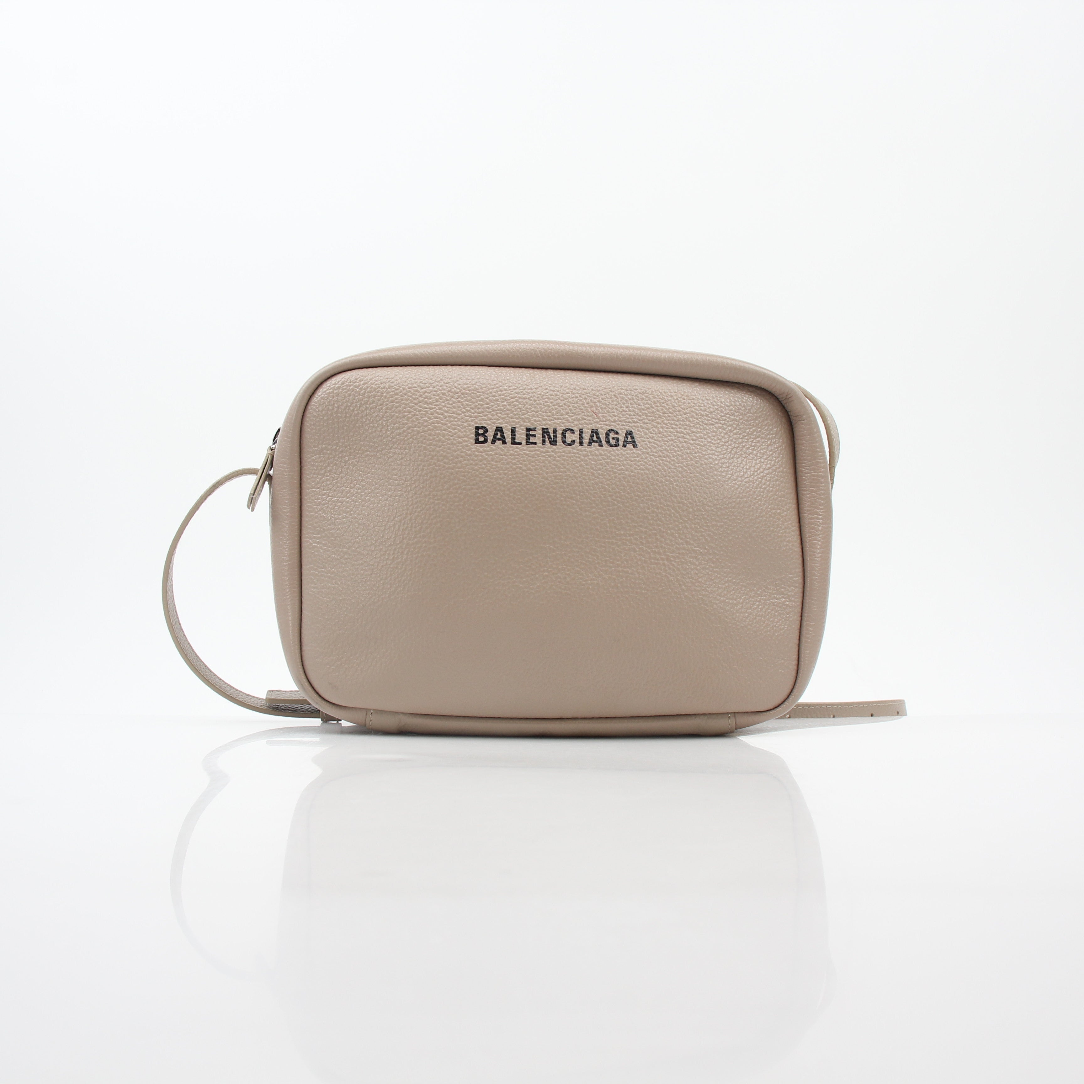 Beige Balenciaga Everyday Camera Bag handbag with gold hardware and adjustable strap, displayed on a neutral background.