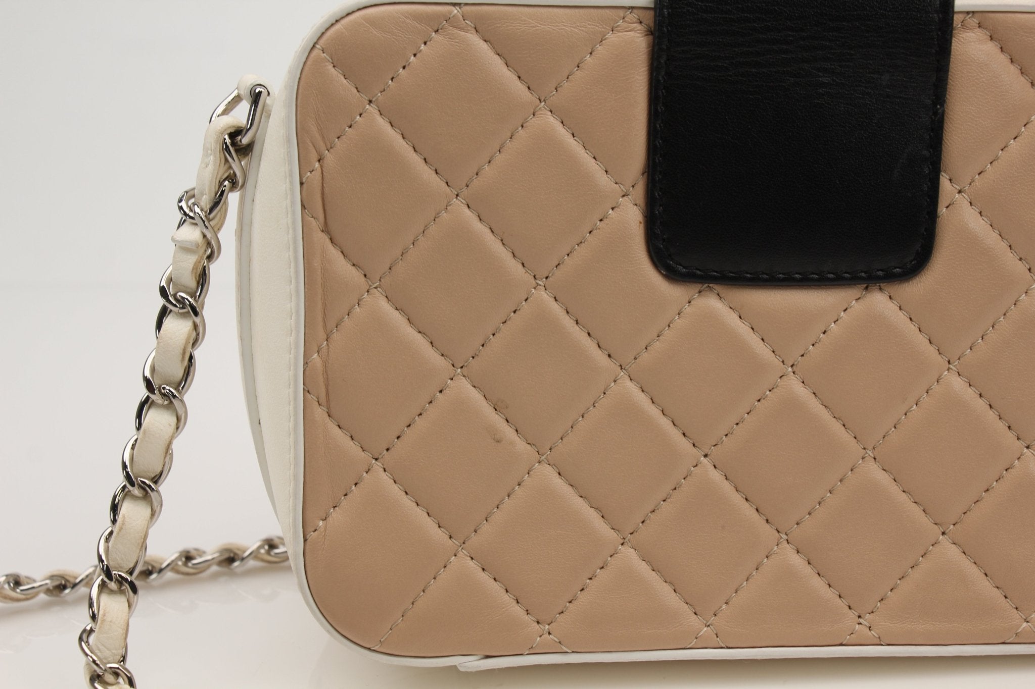 Gold & Beyond Chanel two-tone quilted mini flap handbag with gold chain strap and classic quilted pattern.
