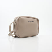 Beige Balenciaga Everyday Camera Bag handbag with gold accents, featuring adjustable strap and signature design details.