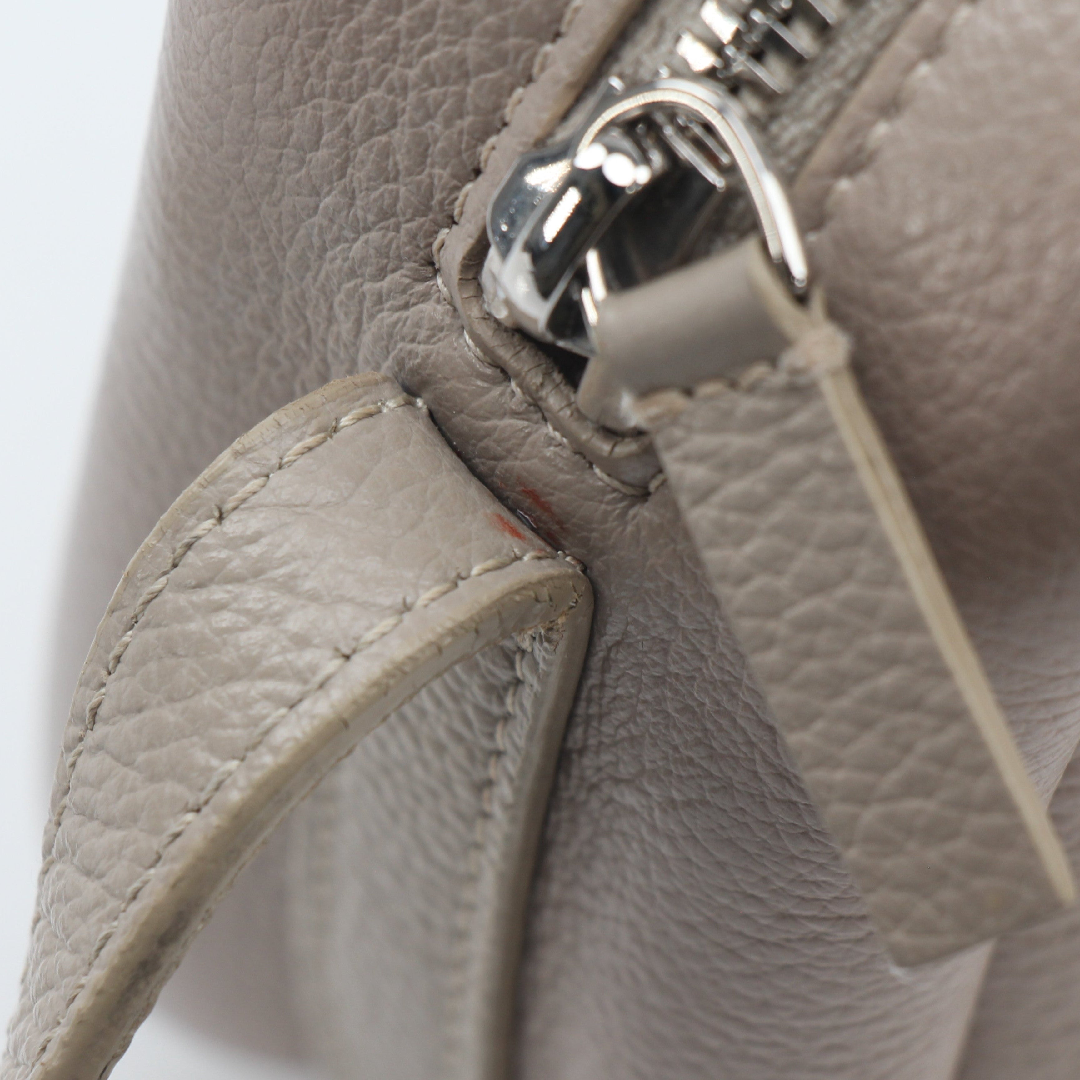 Beige Balenciaga Everyday Camera Bag handbag with gold accents, shown in a close-up shot highlighting its stylish design.