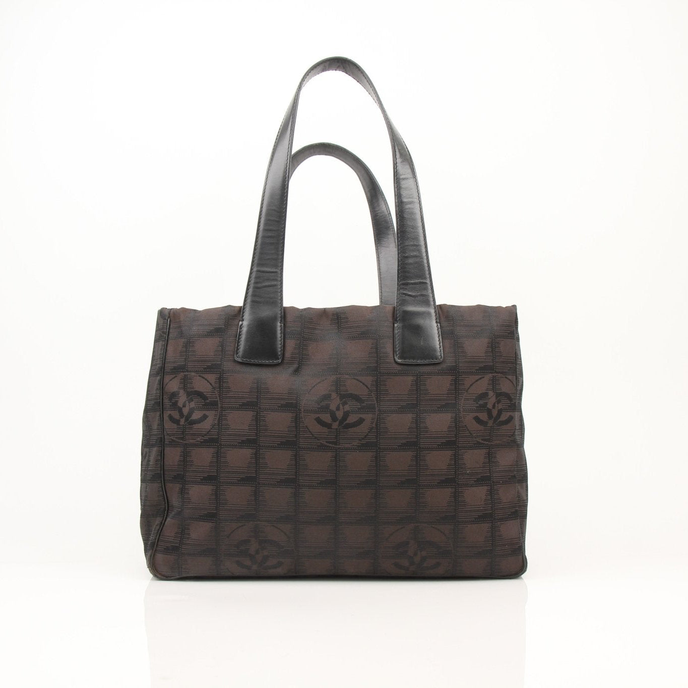 Gold & Beyond Chanel checked nylon tote handbag with black and white plaid design, sturdy handles, and spacious interior.