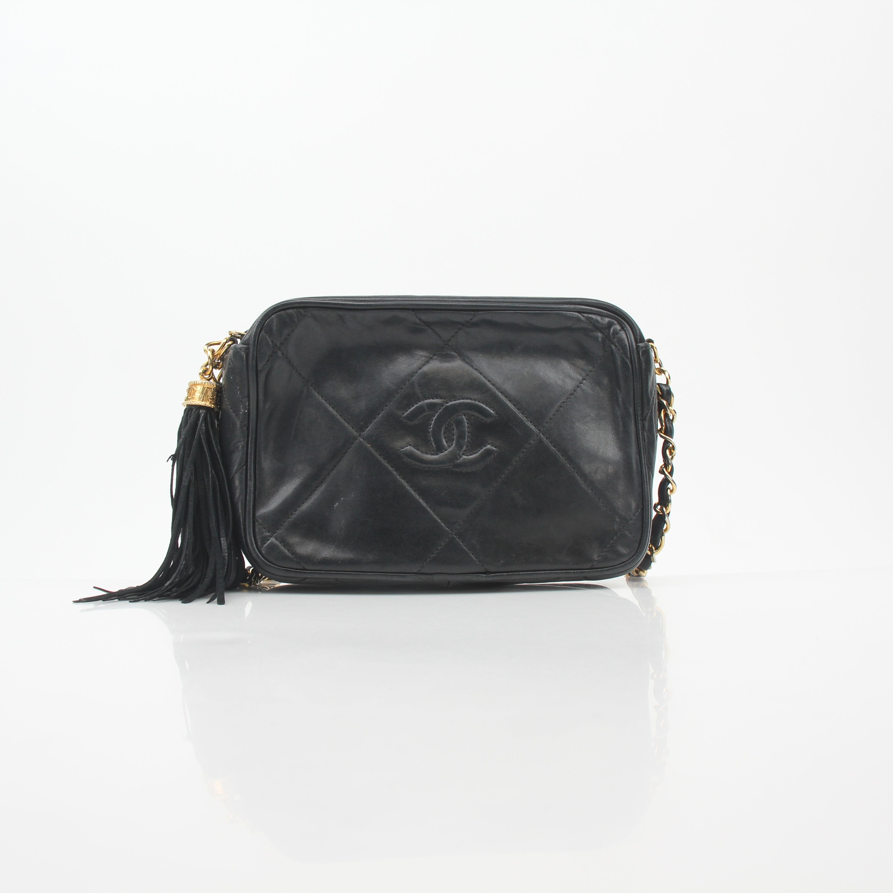 Chanel black vintage quilted tassel camera bag handbag with gold chain strap and classic quilted design.