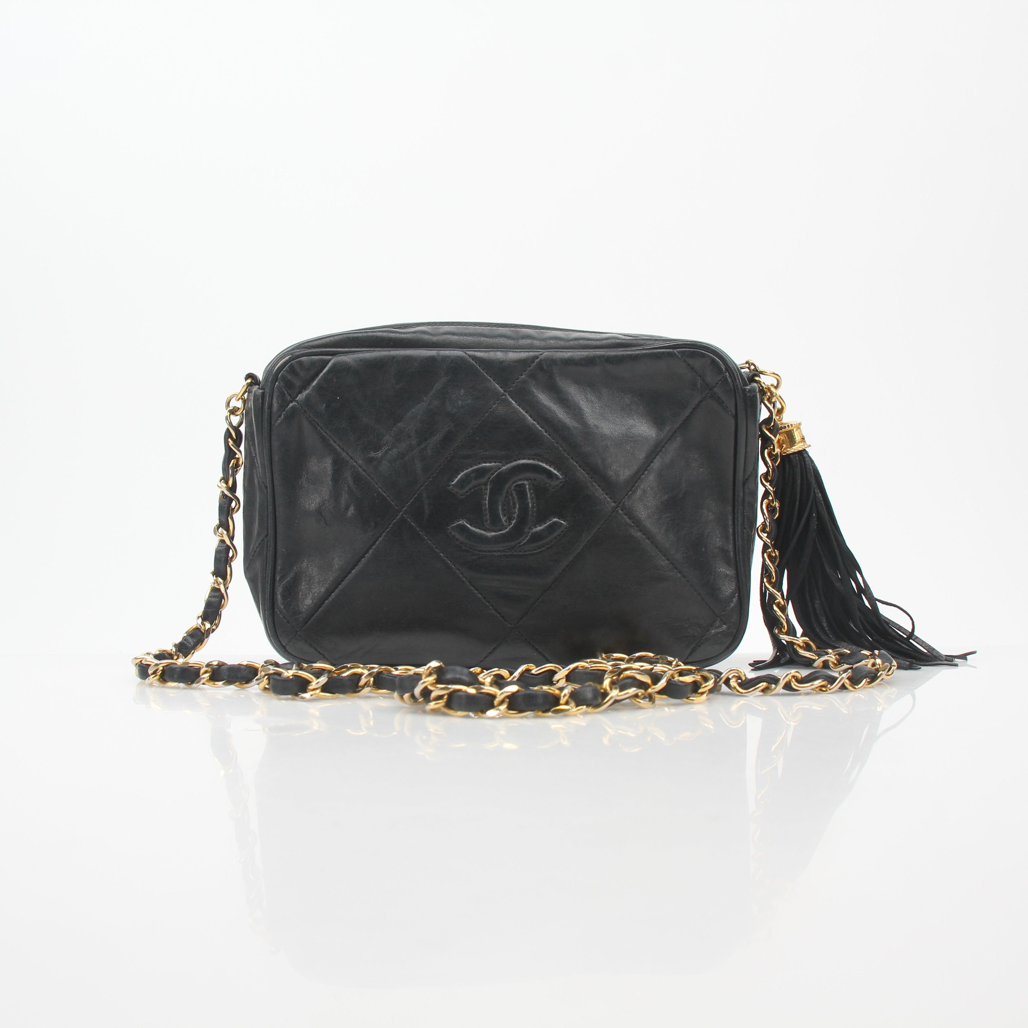 Gold & Beyond Chanel black vintage quilted tassel camera handbag with chain strap and gold accents.