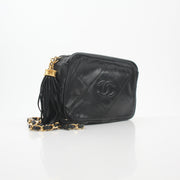 Black vintage Chanel quilted camera handbag with tassel detail and gold hardware, by Gold & Beyond.