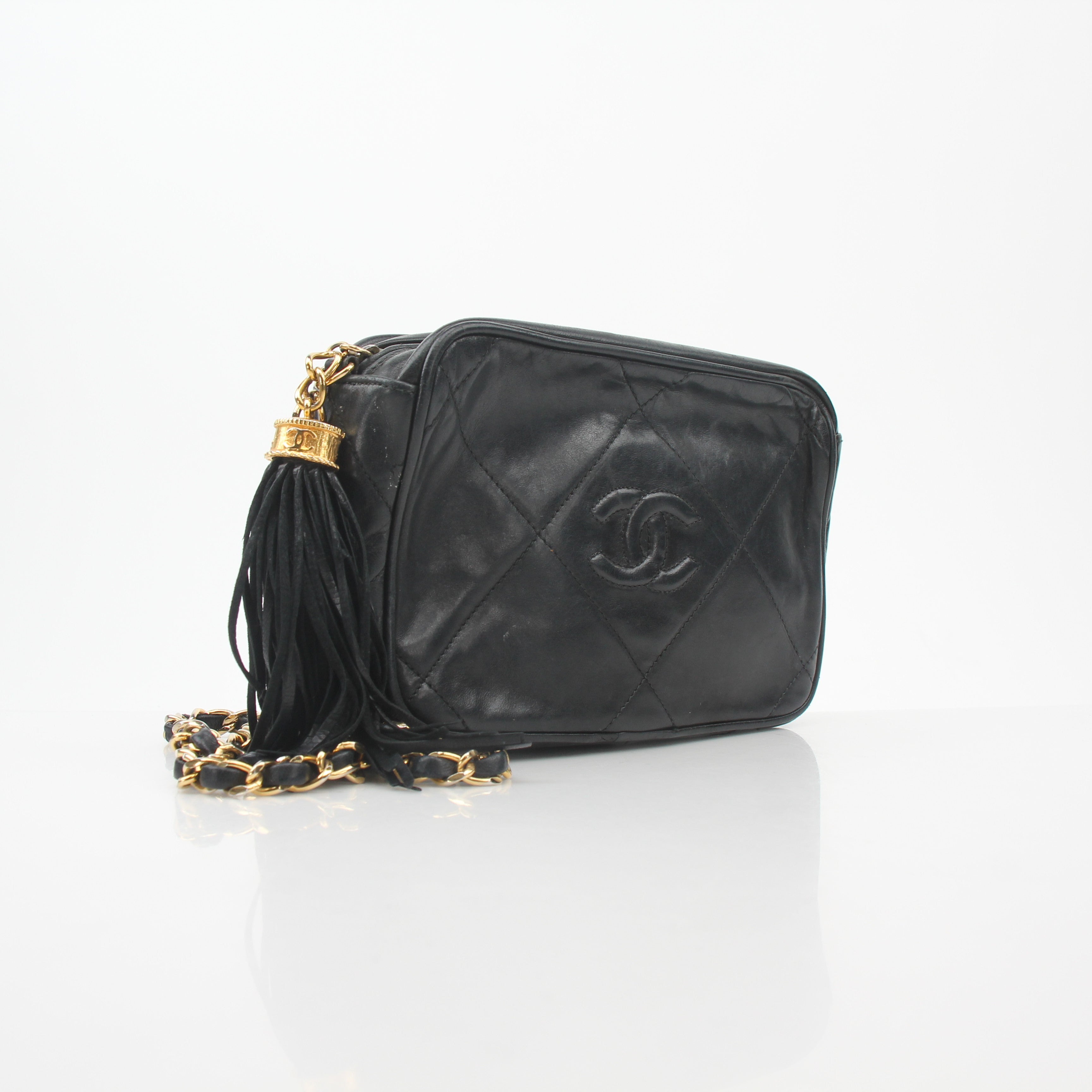 Black vintage Chanel quilted camera handbag with tassel detail and gold hardware, by Gold & Beyond.