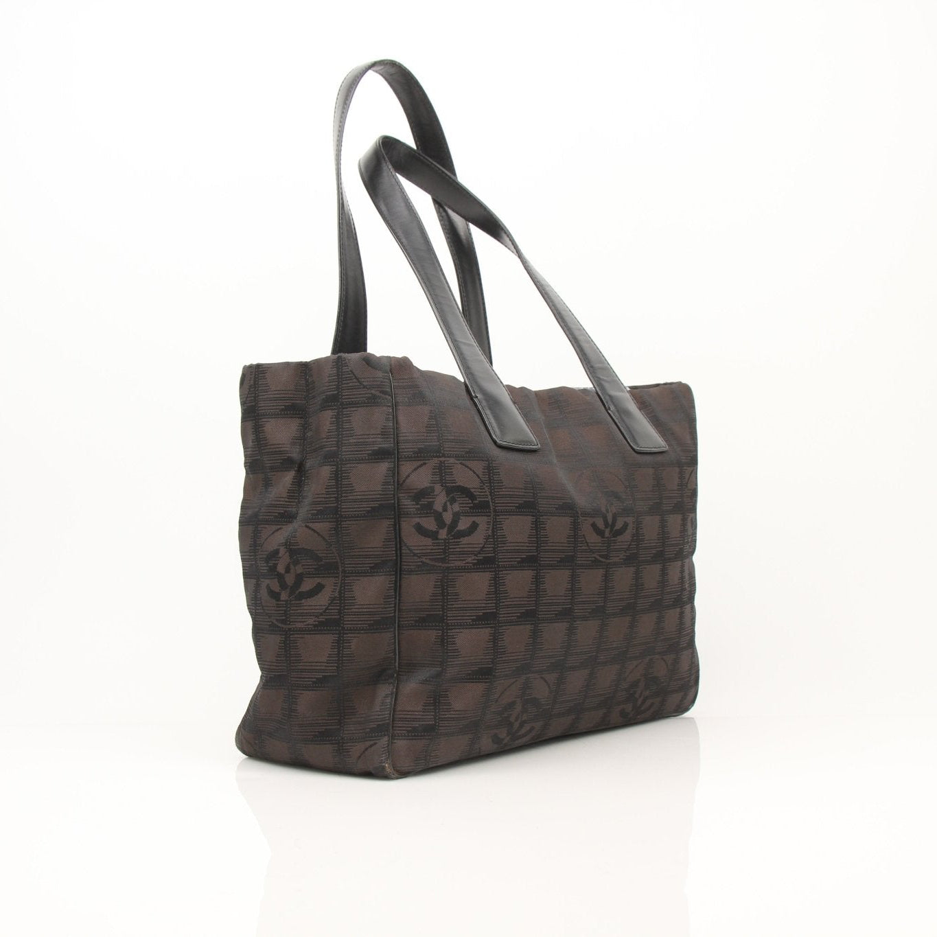Chanel checked nylon tote handbag with black handles and gold accents, stylish and spacious for everyday use.