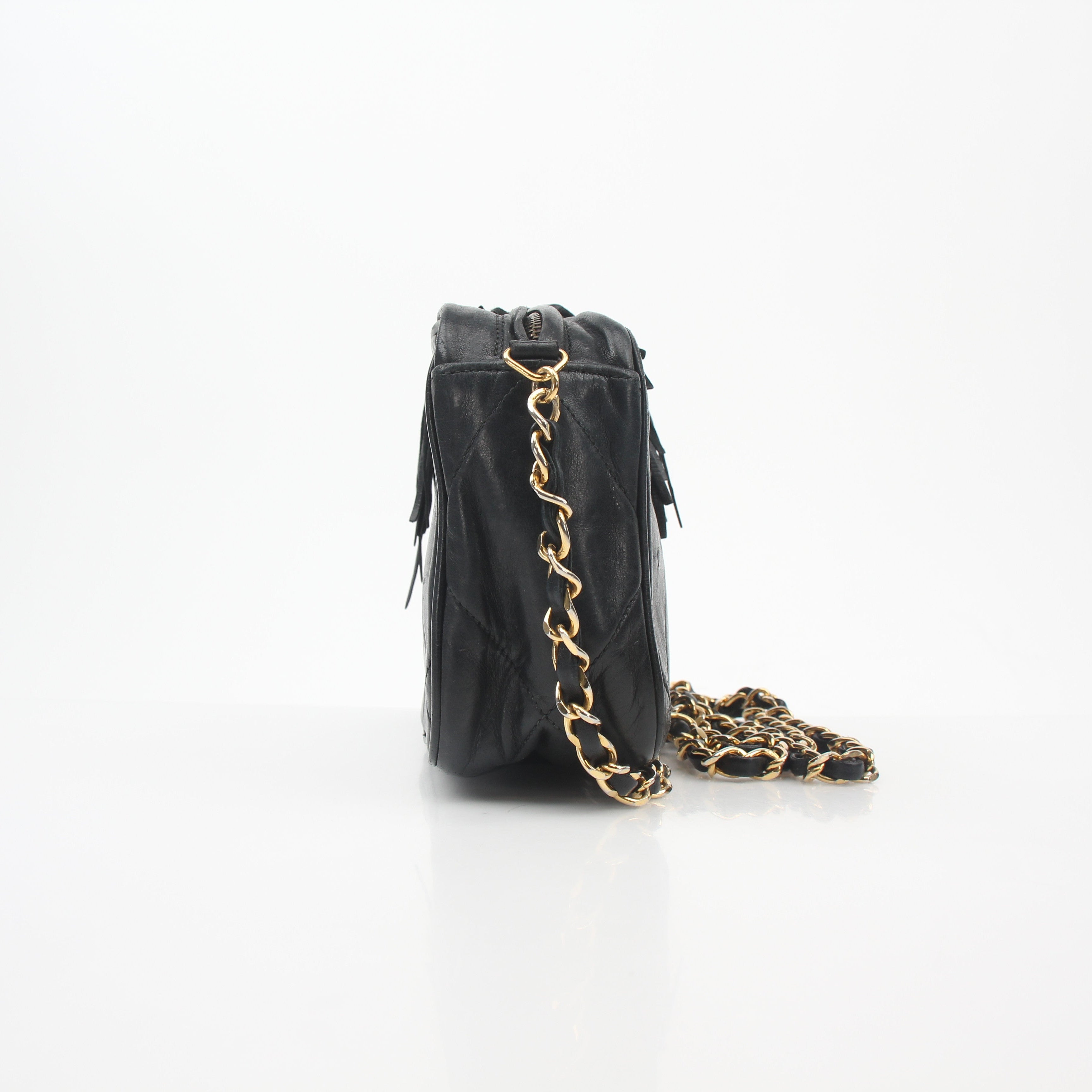 Chanel black vintage quilted tassel camera bag handbag with gold accents and chain strap, featuring a classic design.