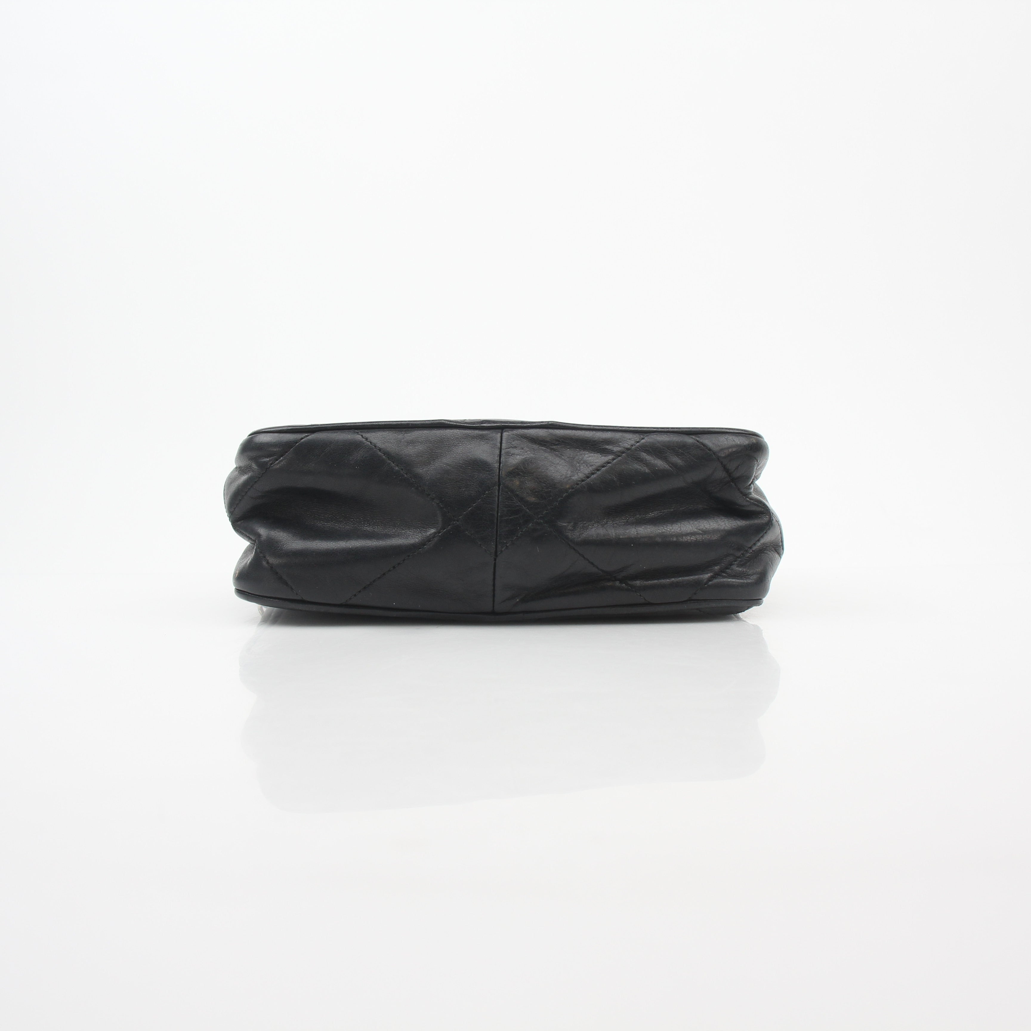 Black vintage Chanel quilted tassel camera bag handbag with gold chain strap and classic design.