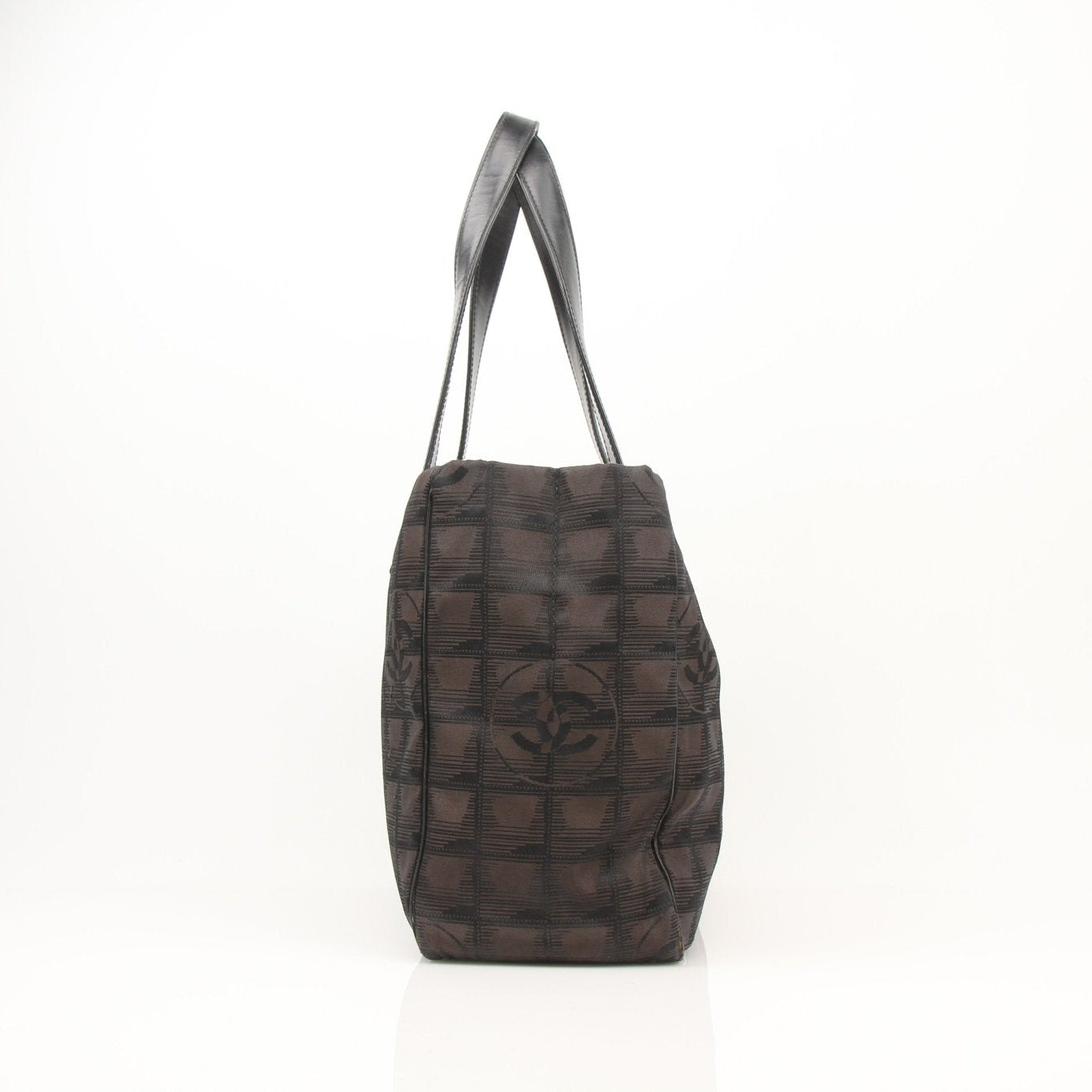 Checked nylon Chanel tote handbag with black and white pattern, featuring sturdy handles and spacious interior.