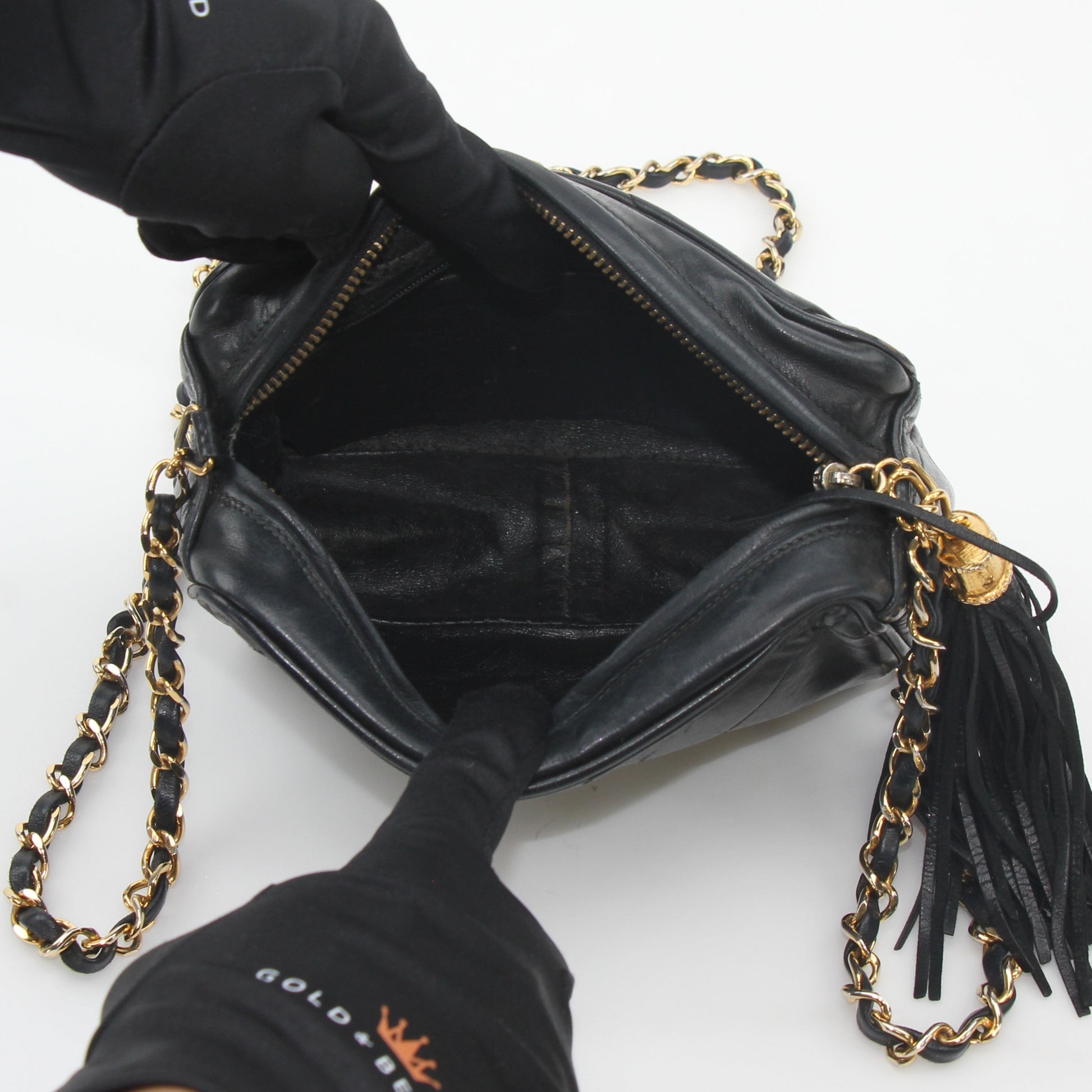 Gold & Beyond Chanel black vintage quilted tassel camera handbag, stylish leather handbag with gold hardware and tassel accents.
