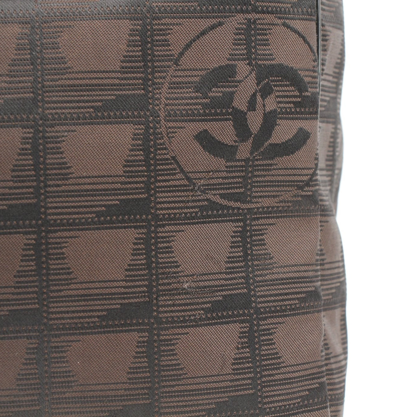 Chanel checked nylon tote handbag with black and white pattern, gold hardware, and double top handles, stylish and spacious.