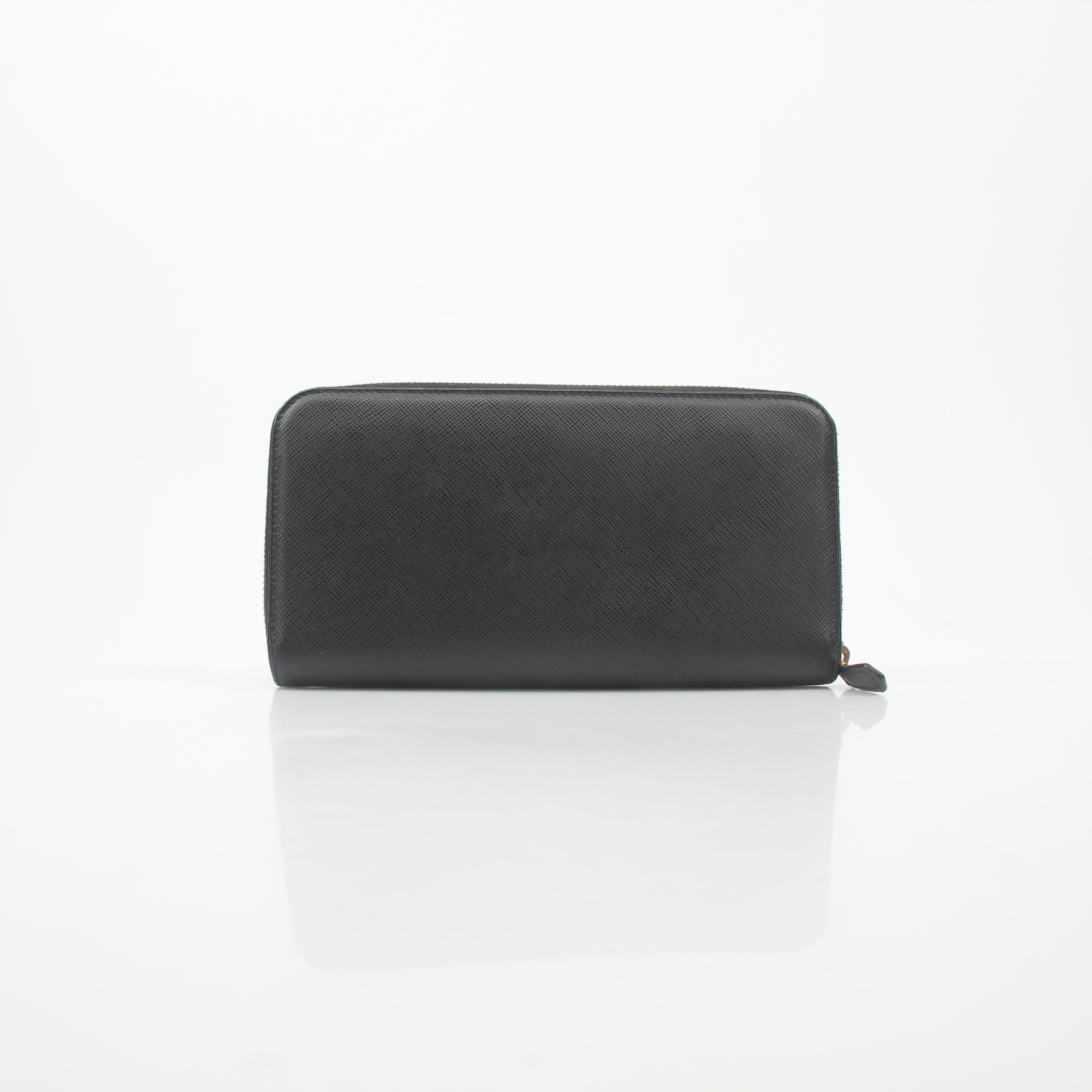 Prada black saffiano leather triangle zip-around wallet with gold hardware, compact and stylish for everyday use.