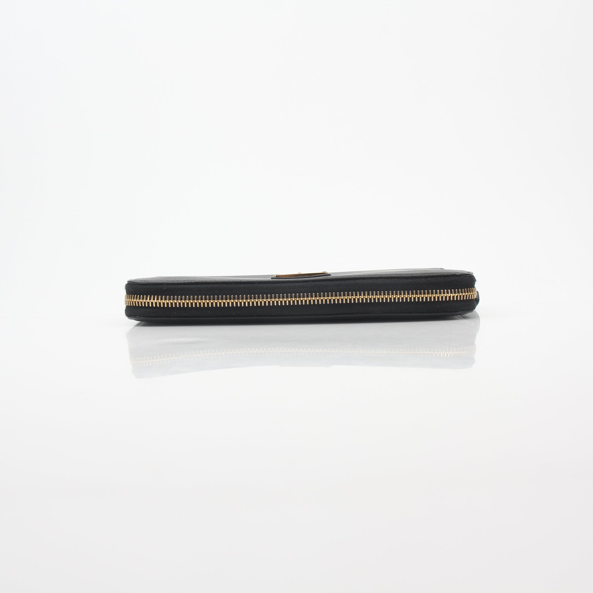 Prada black saffiano leather triangle zip-around wallet with gold-tone hardware and compact design.
