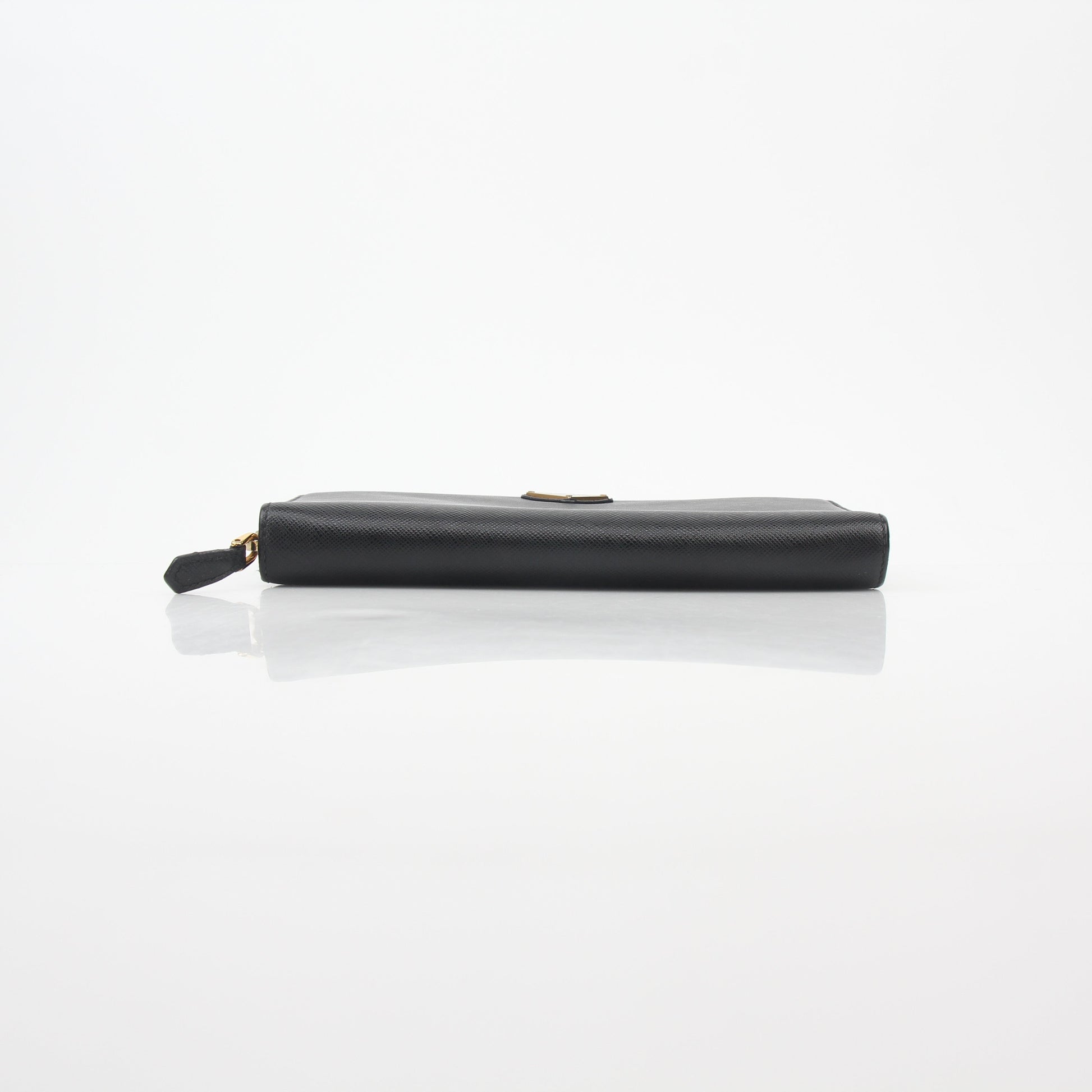 Prada black saffiano leather triangle zip-around wallet with gold accents, featuring multiple card slots and a compact design.