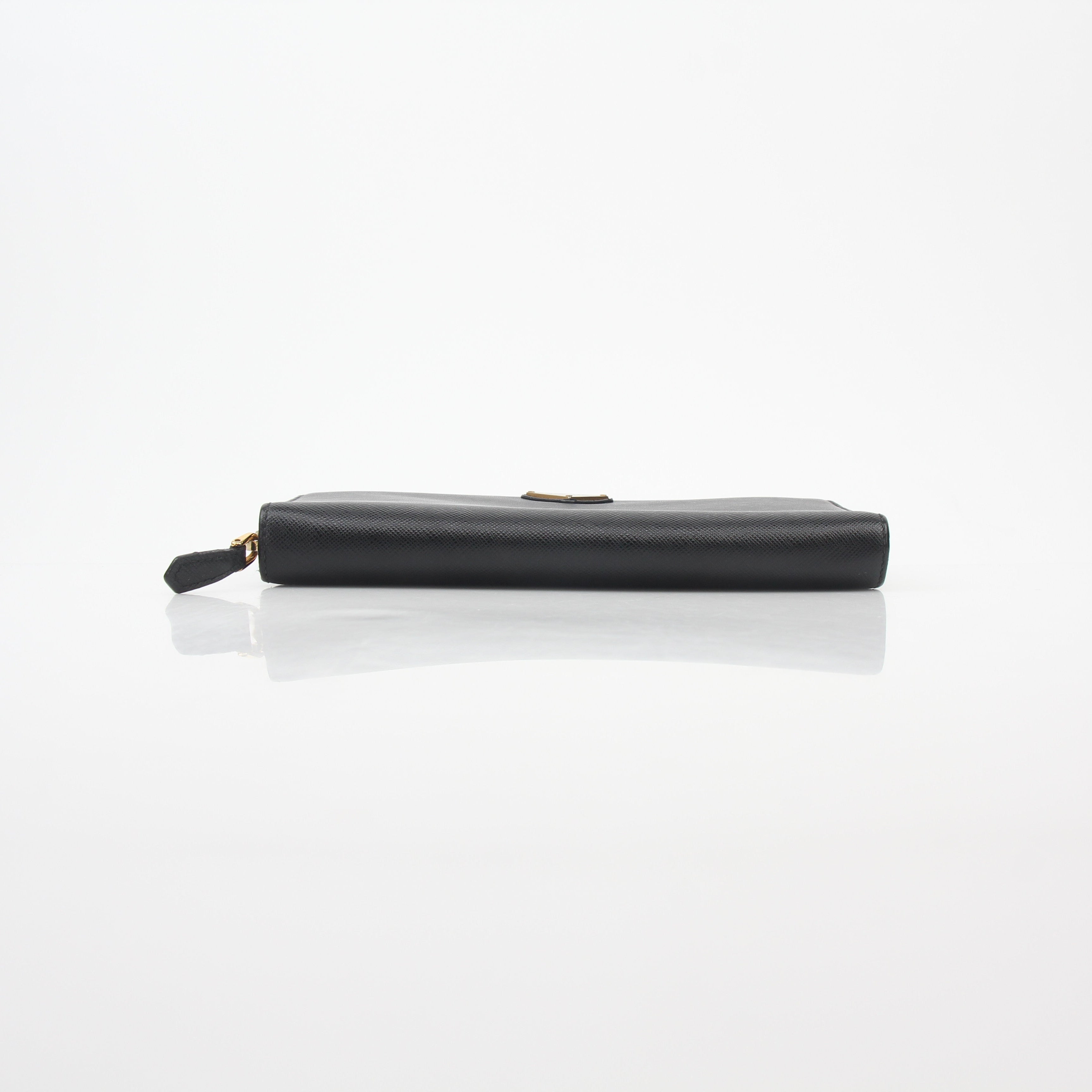 Prada black saffiano leather triangle zip-around wallet with gold accents, featuring multiple card slots and a compact design.