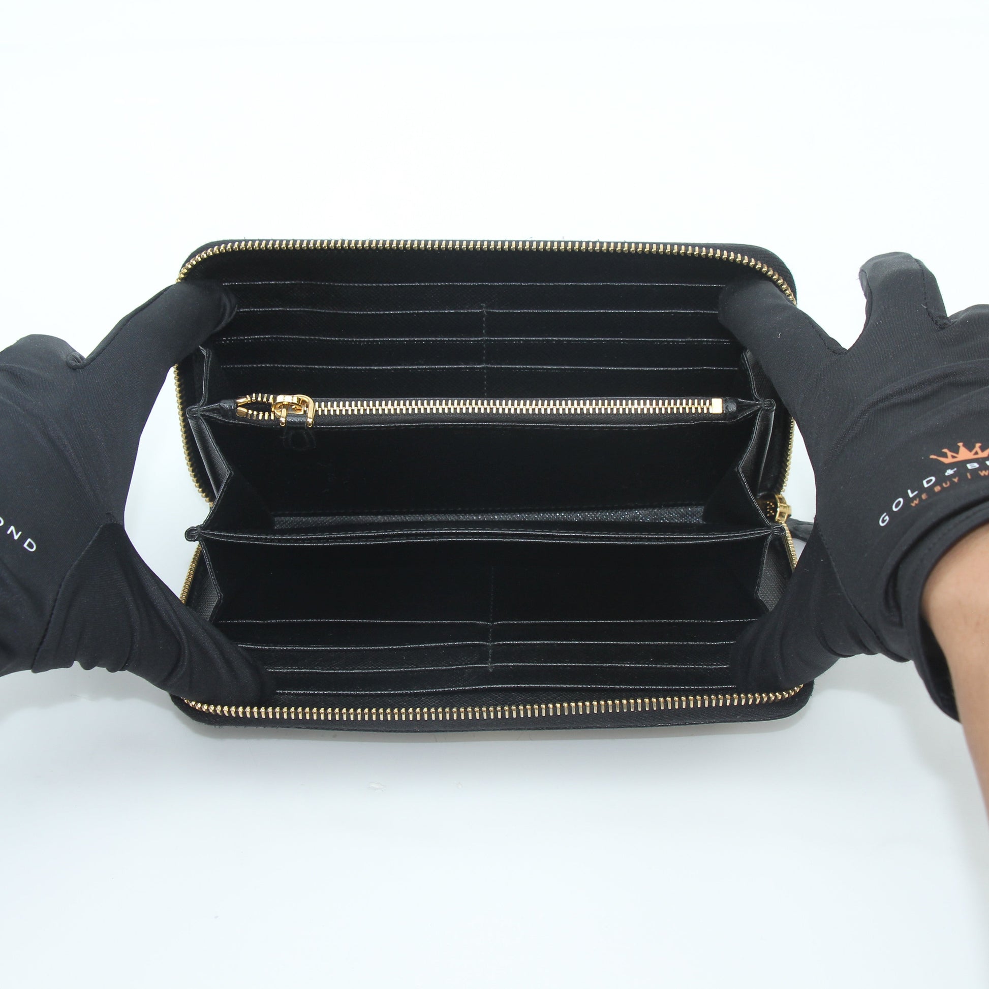 Prada black saffiano leather triangle zip-around wallet with gold accents, featuring multiple card slots and a sleek design.