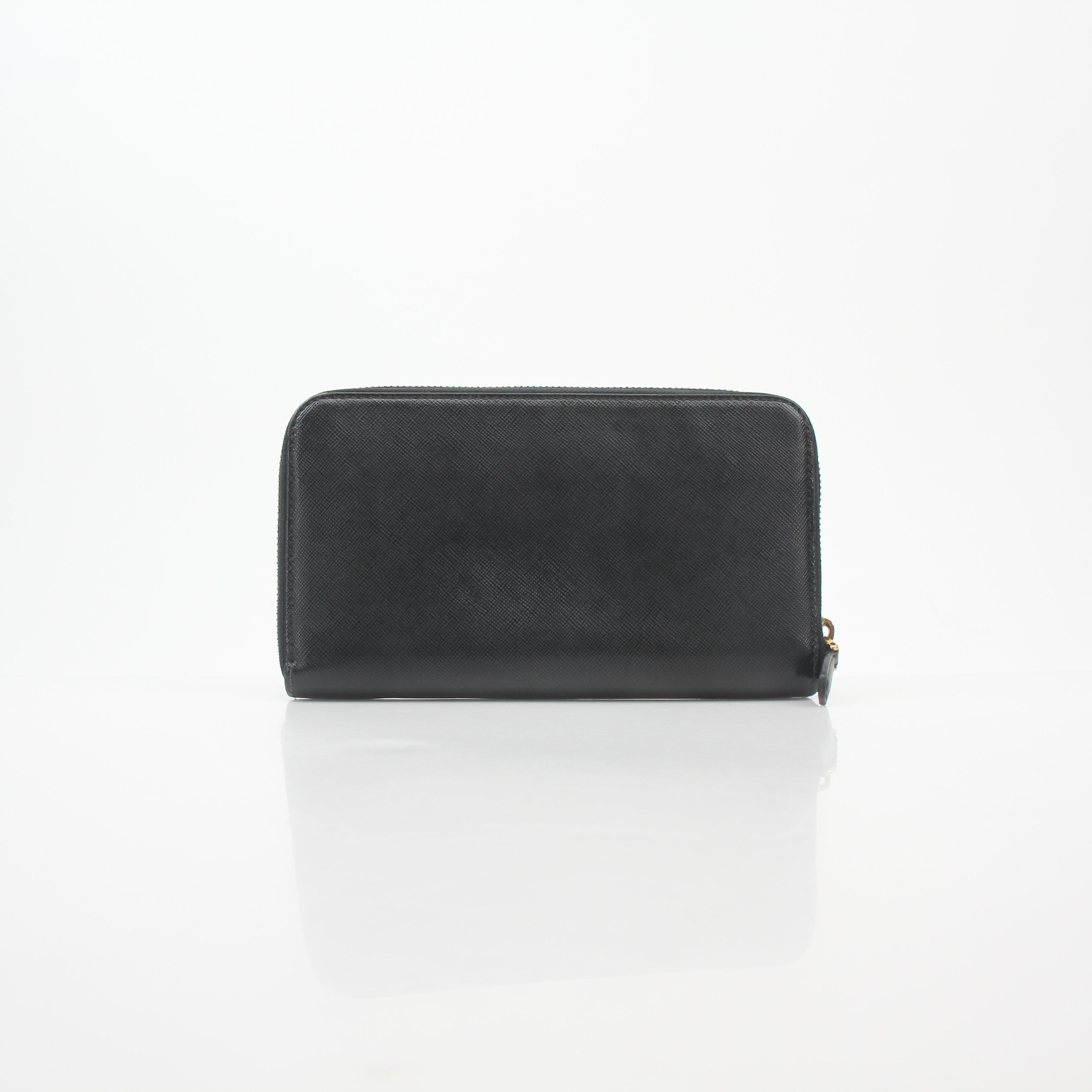 Prada black saffiano leather zip-around wallet with metal logo, featuring a sleek design and multiple card slots.