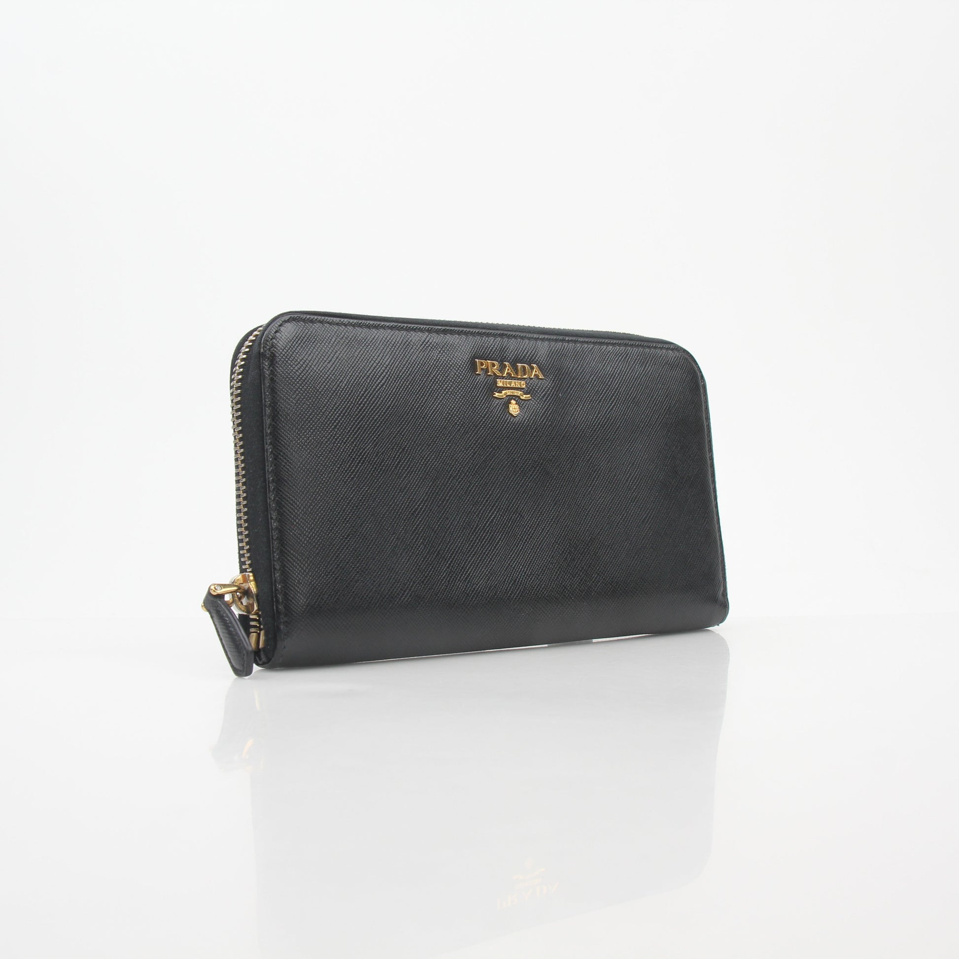 Prada black saffiano leather zip-around wallet with metal logo, featuring a sleek design and multiple card slots.