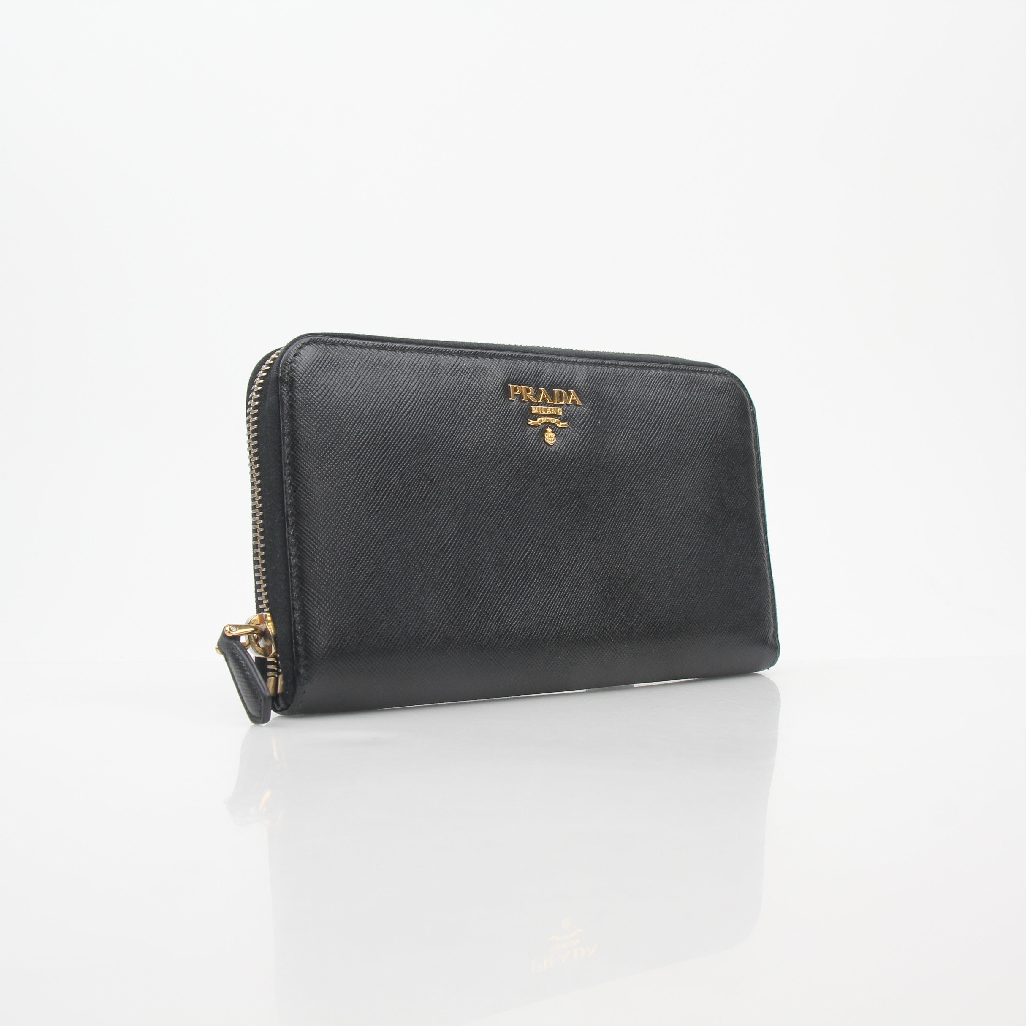 Prada black saffiano leather zip-around wallet with metal logo, featuring a sleek design and multiple card slots.