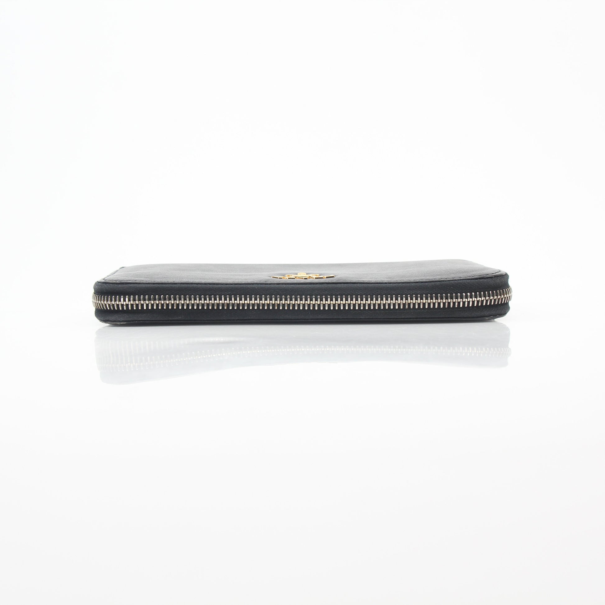 Prada black saffiano leather zip-around wallet with metal logo, featuring multiple card slots and a sleek design.
