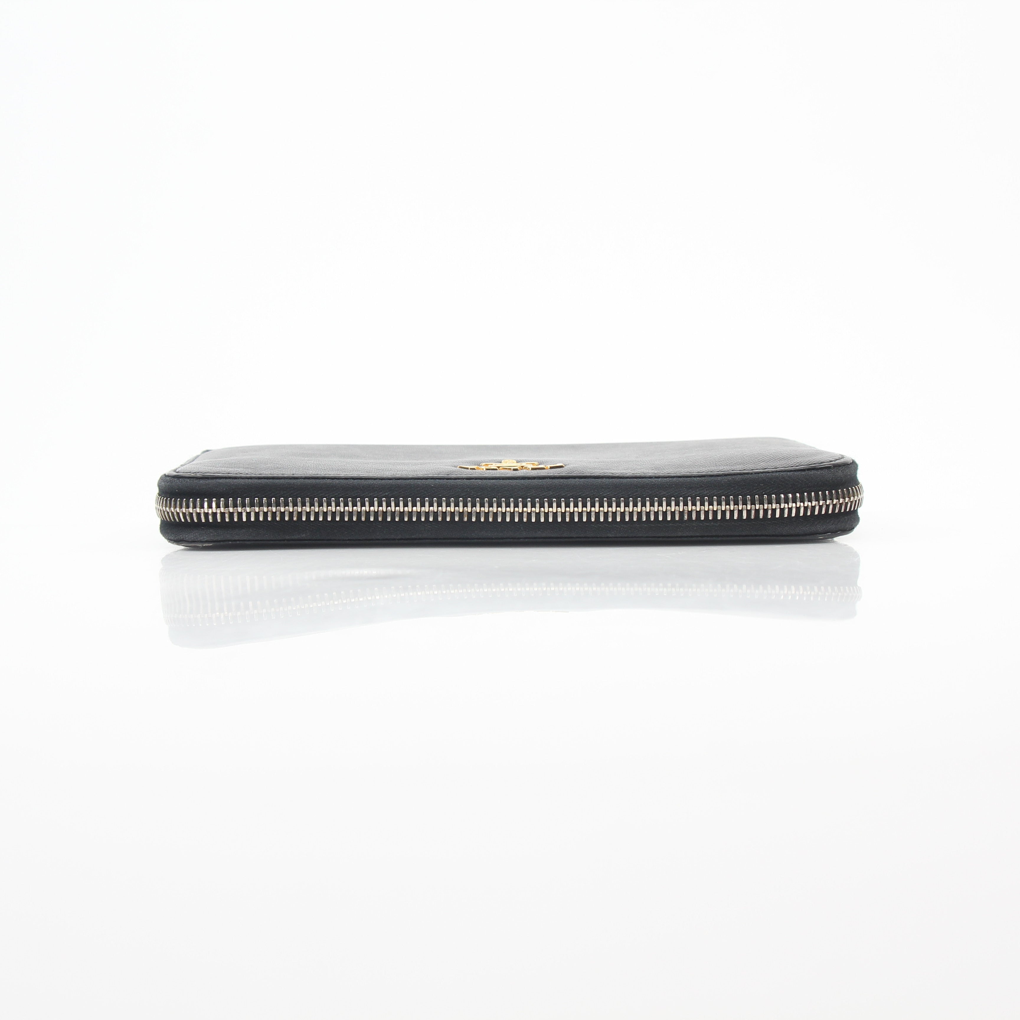Prada black saffiano leather zip-around wallet with metal logo, featuring multiple card slots and a sleek design.