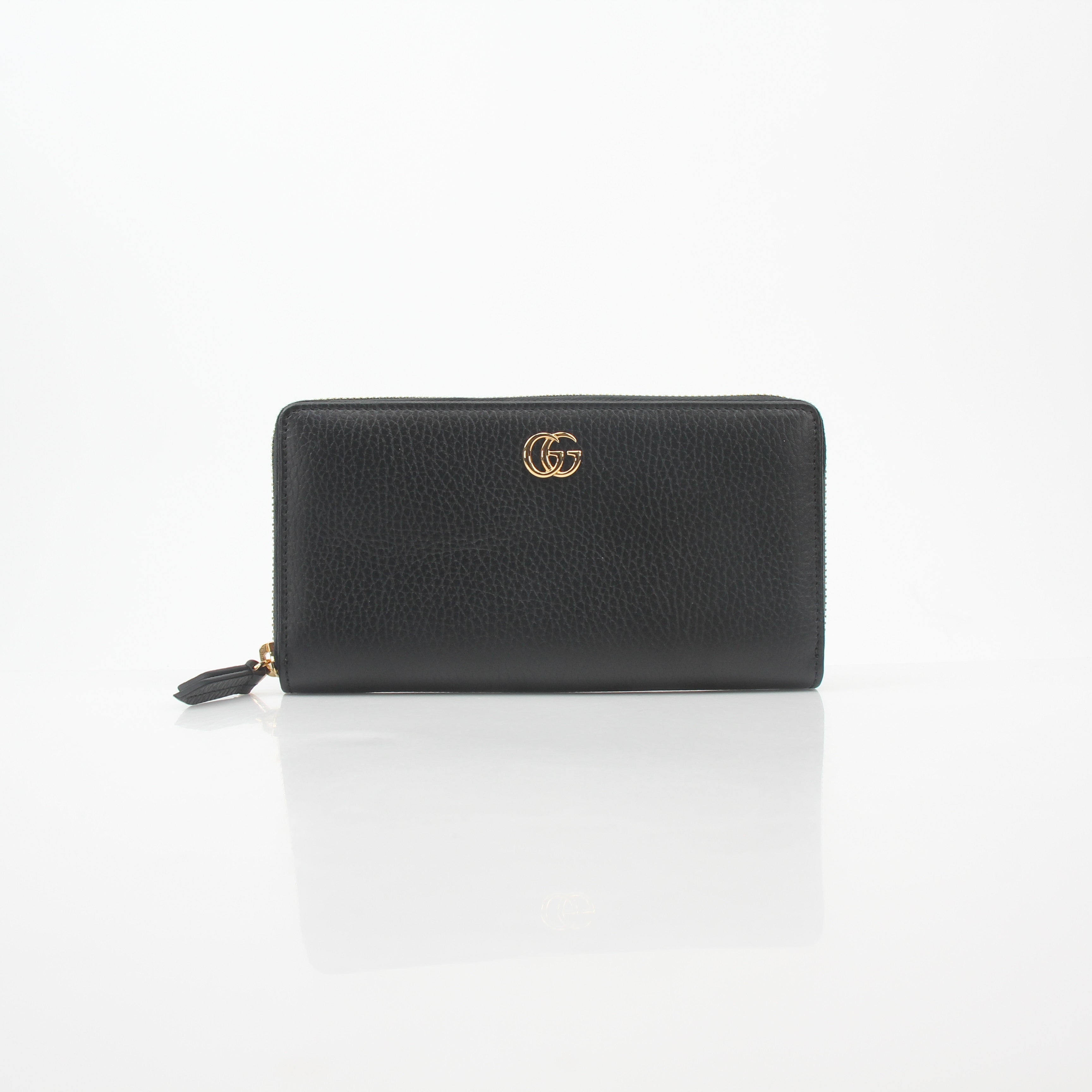 Gucci Black GG Marmont zip-around wallet with gold-tone hardware and quilted chevron leather design.