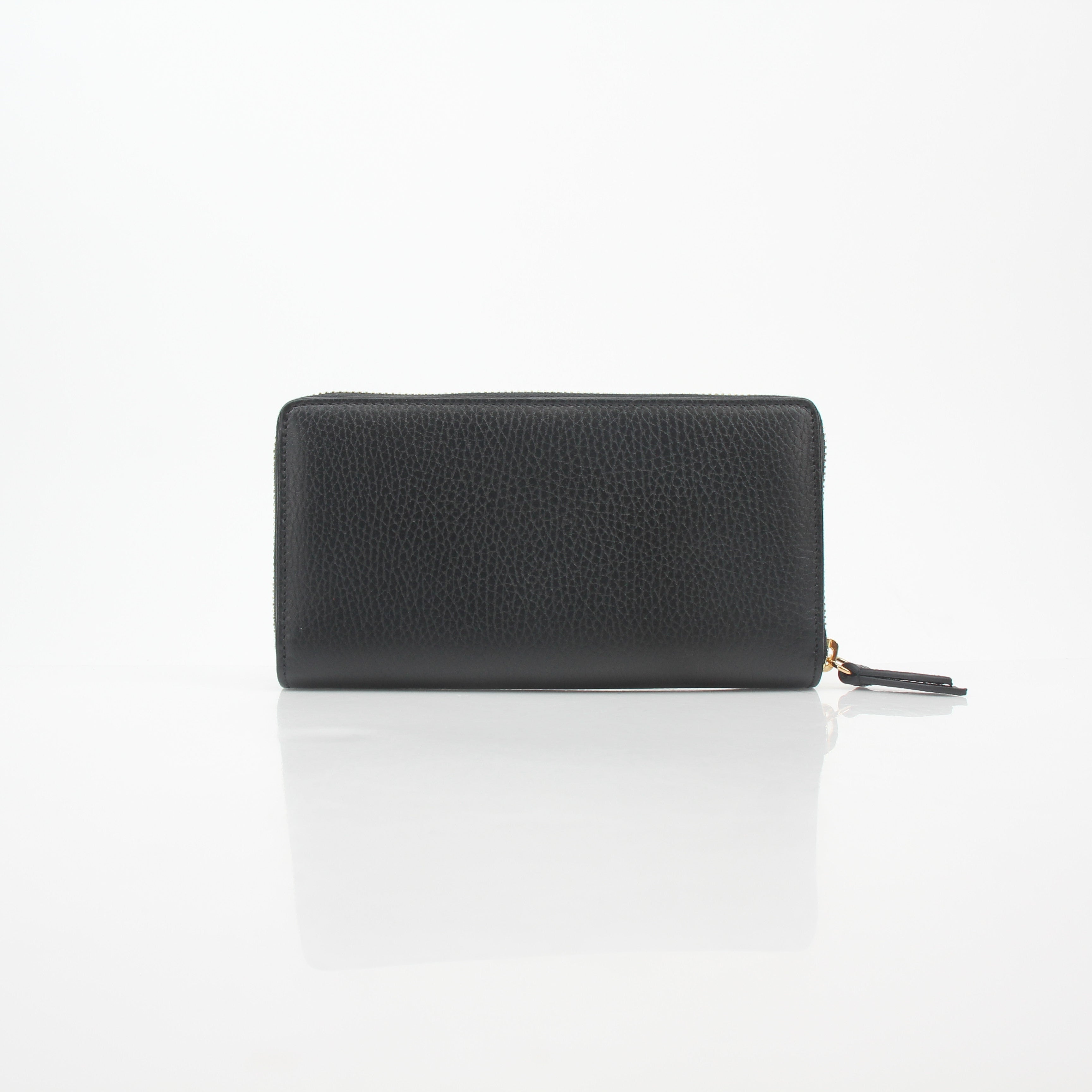 Gucci black GG Marmont zip-around wallet with gold-toned hardware and quilted chevron leather design.