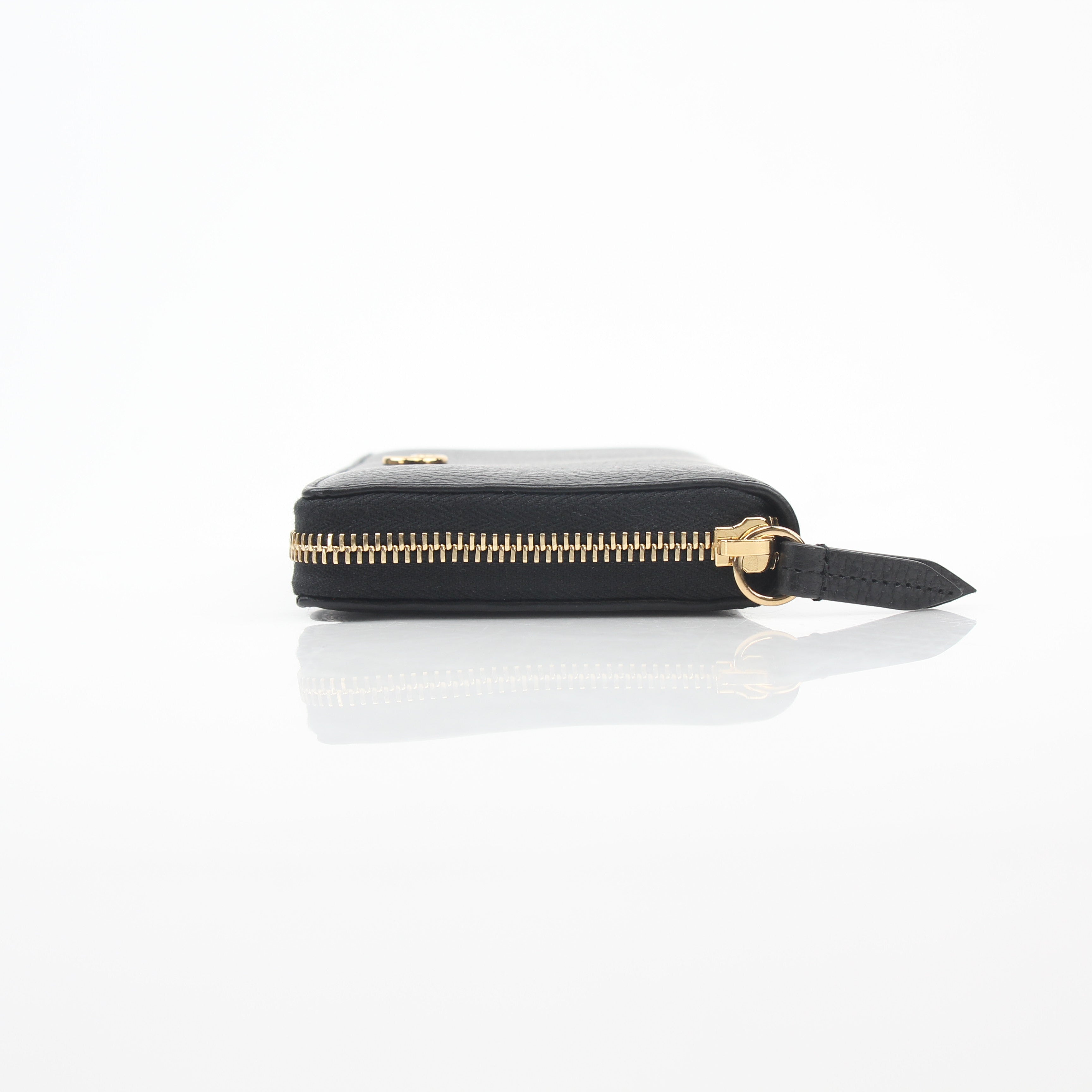 Gucci Black GG Marmont zip-around wallet with gold-tone hardware and chevron quilted leather, displayed on a neutral background.