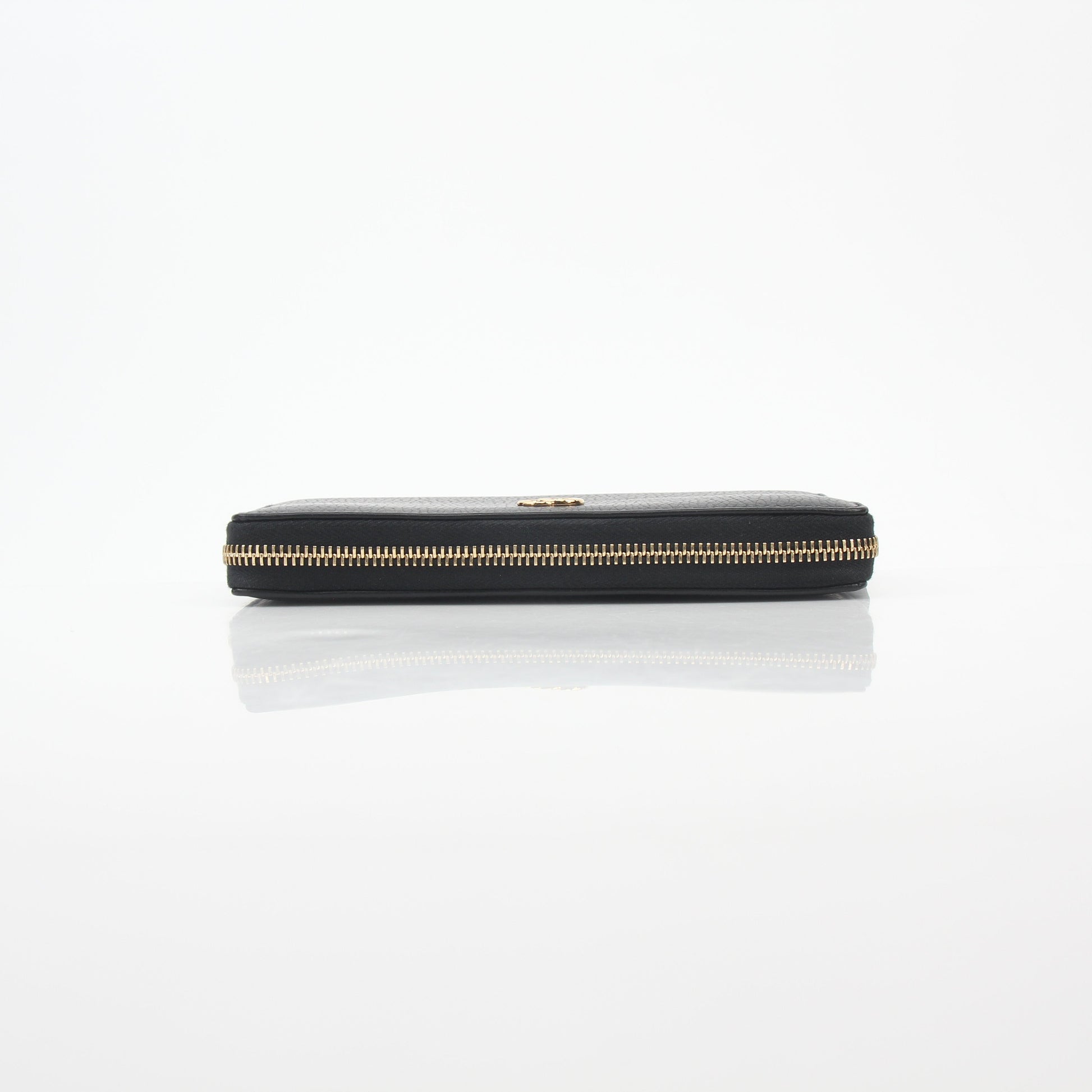 Gucci black GG Marmont zip-around wallet with gold hardware, featuring quilted leather and a compact, stylish design.