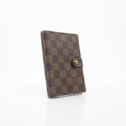 Louis Vuitton Damier Ebene Ring Agenda PM cover with gold hardware, featuring the signature checkered pattern and compact design.