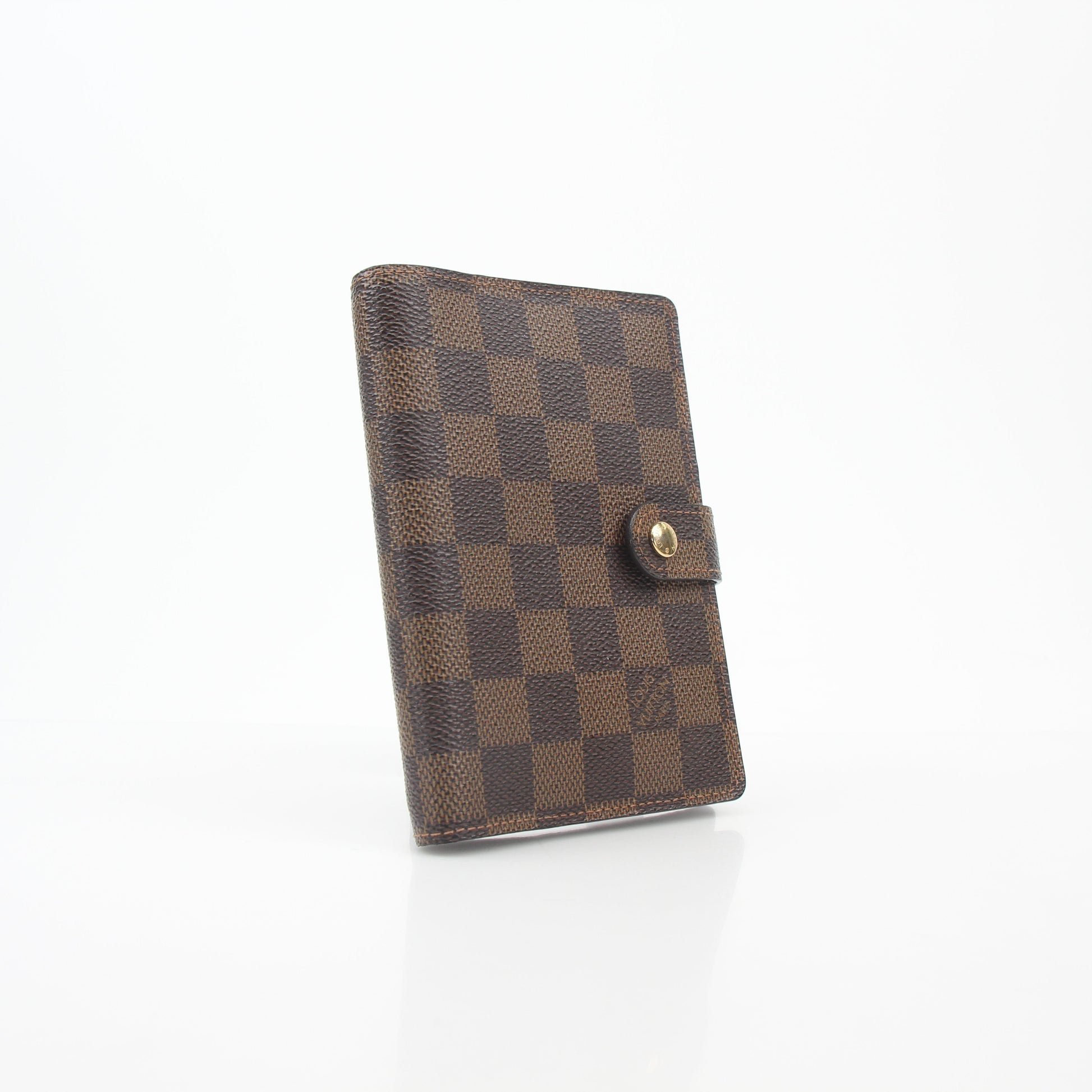 Louis Vuitton Damier Ebene Ring Agenda PM cover with gold hardware, featuring the signature checkered pattern and compact design.