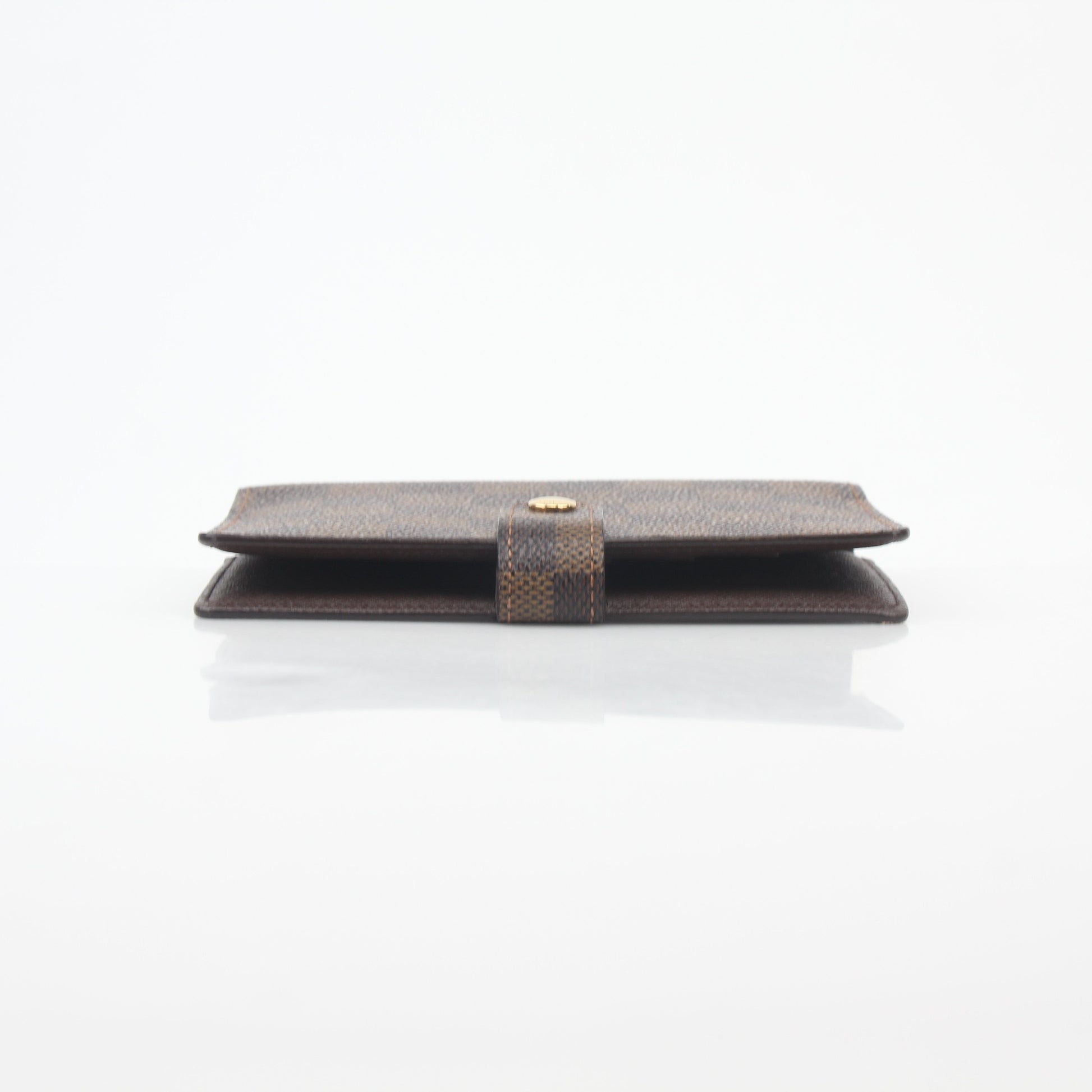 Louis Vuitton Damier Ebene Ring Agenda PM Cover accessory with brown checkered pattern and gold accents.