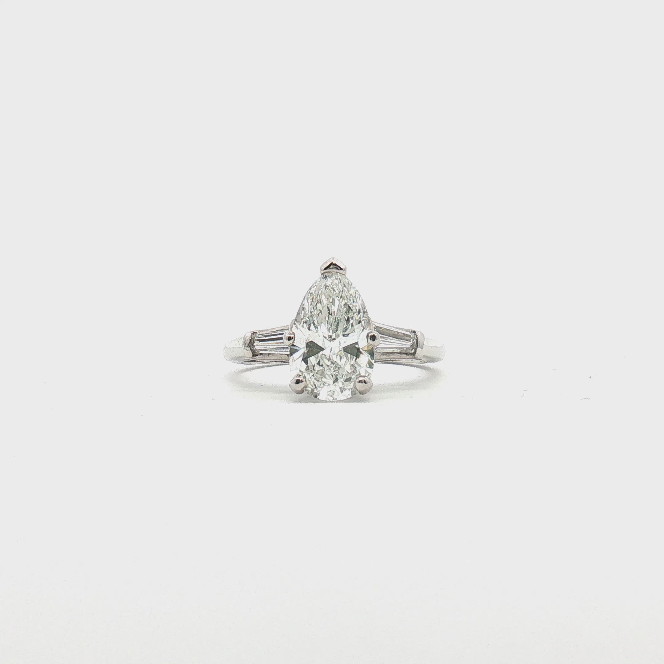 Load video: Platinum Pear Diamond Three-Stone Ring